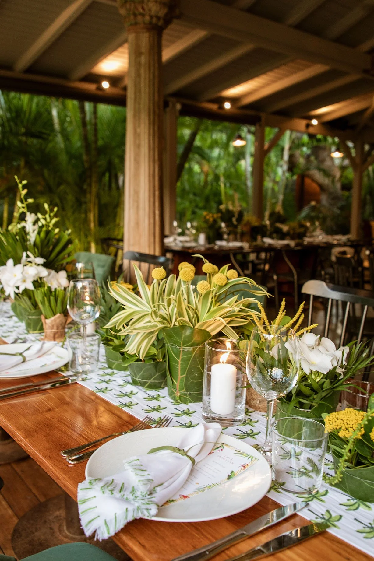 Elegant wedding dinner setup with white floral centerpieces, candles, and natural charm in St Barth.