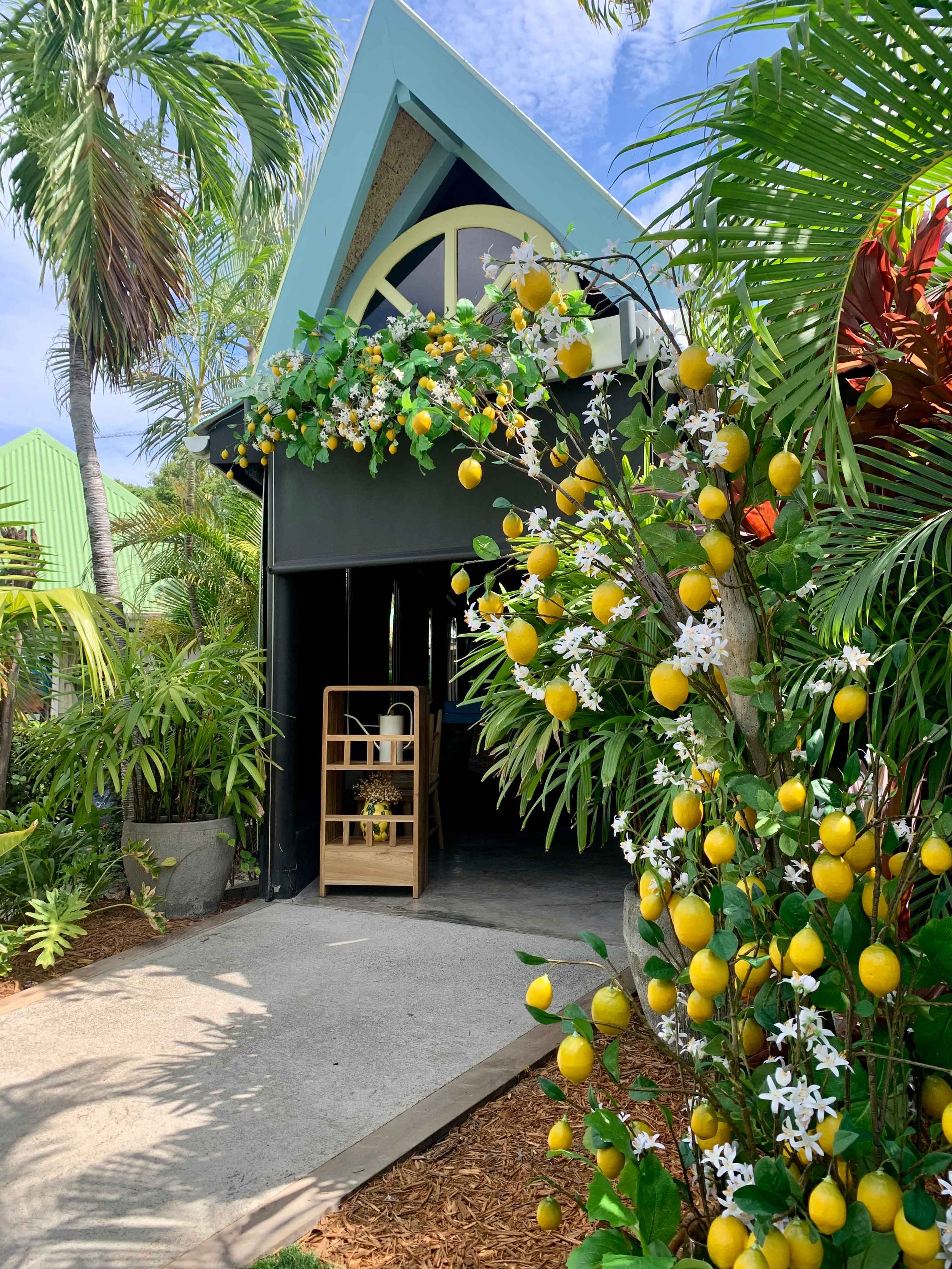 Floral restaurant entrance featuring lush greenery, lemons, and white flowers for a Mediterranean-inspired ambiance in St Barth.