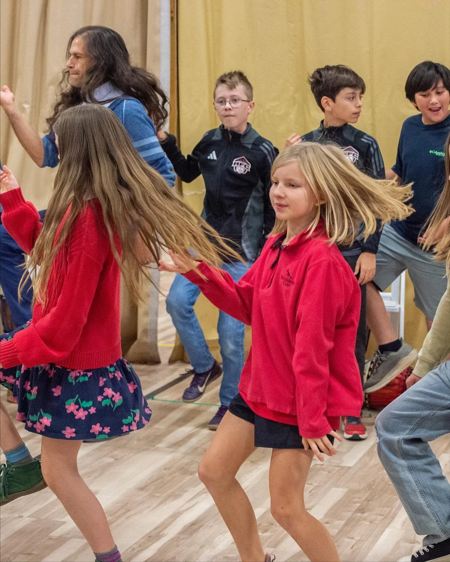 children dancing happily in an expert led cultural experience