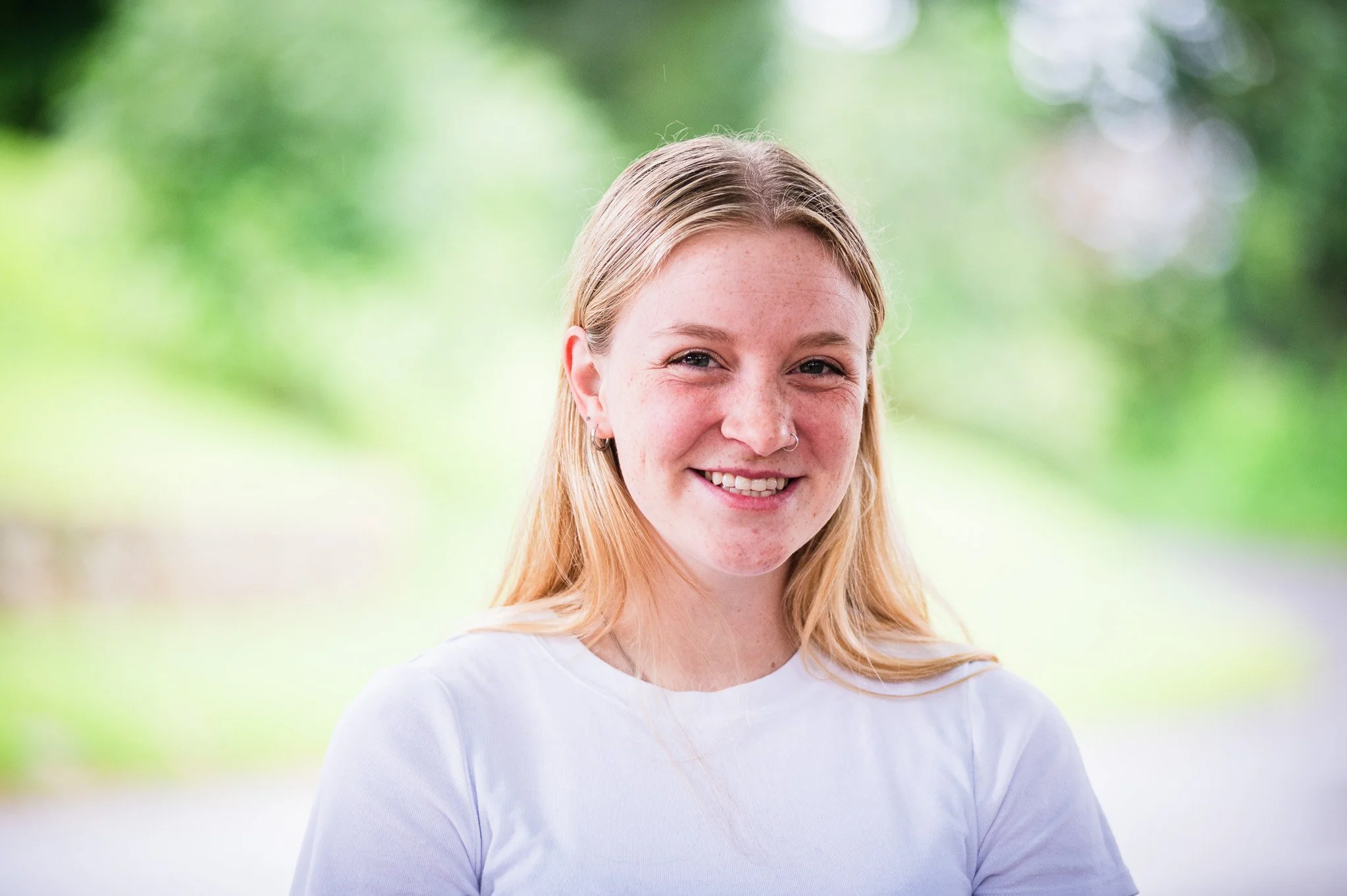 smiling young woman with blonde hair posing for portrait