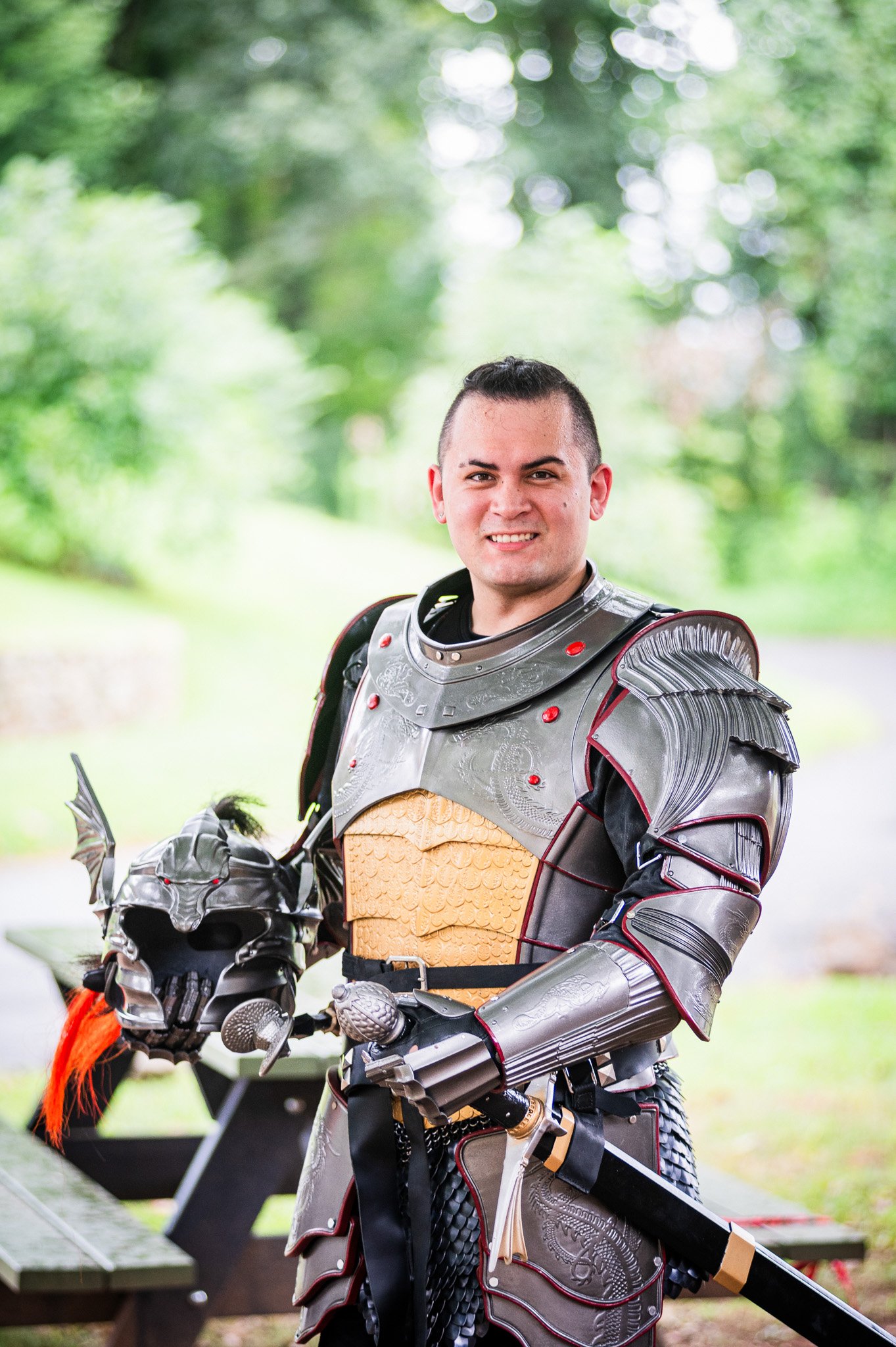 A man wearing cosplay armor in a woodland portrait