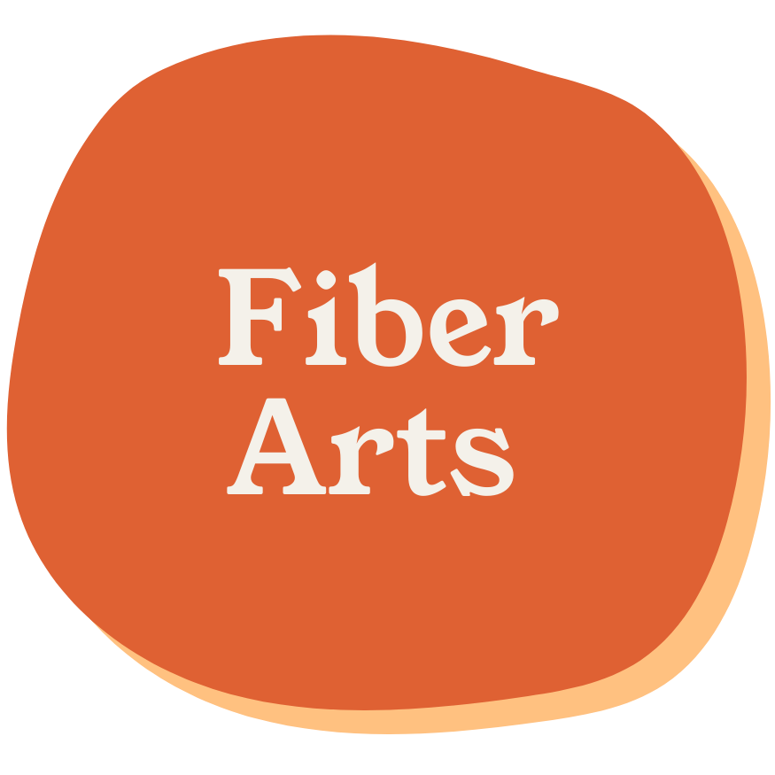 Logo for Fiber Arts featuring a rounded orange shape with the text 'Fiber Arts' in white.