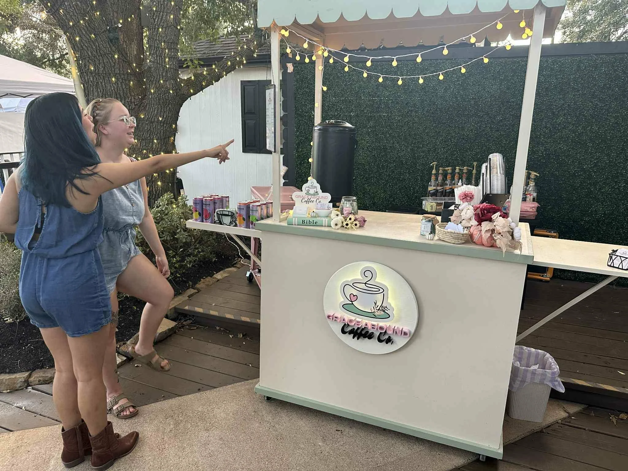 Guests pointing at the Grace Abound Coffee Co. mobile coffee bar at a private event in Houston, Texas