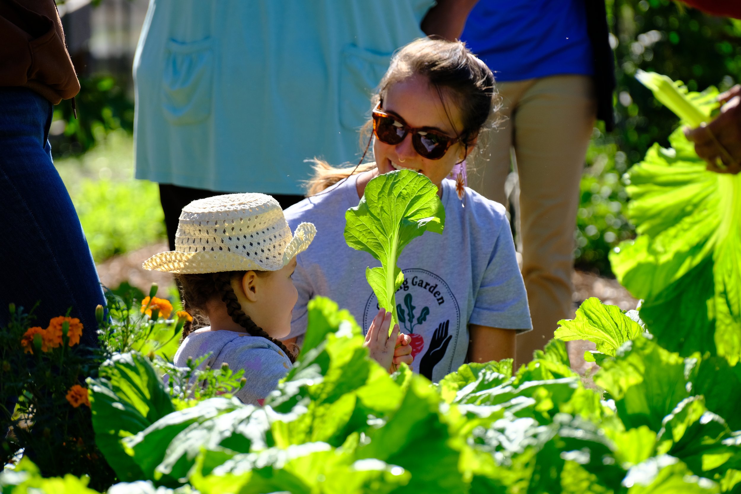 adult and child sit in a garden