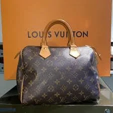 Borsa Louis Vuitton Speedy in tela monogram davanti alla sua scatola
