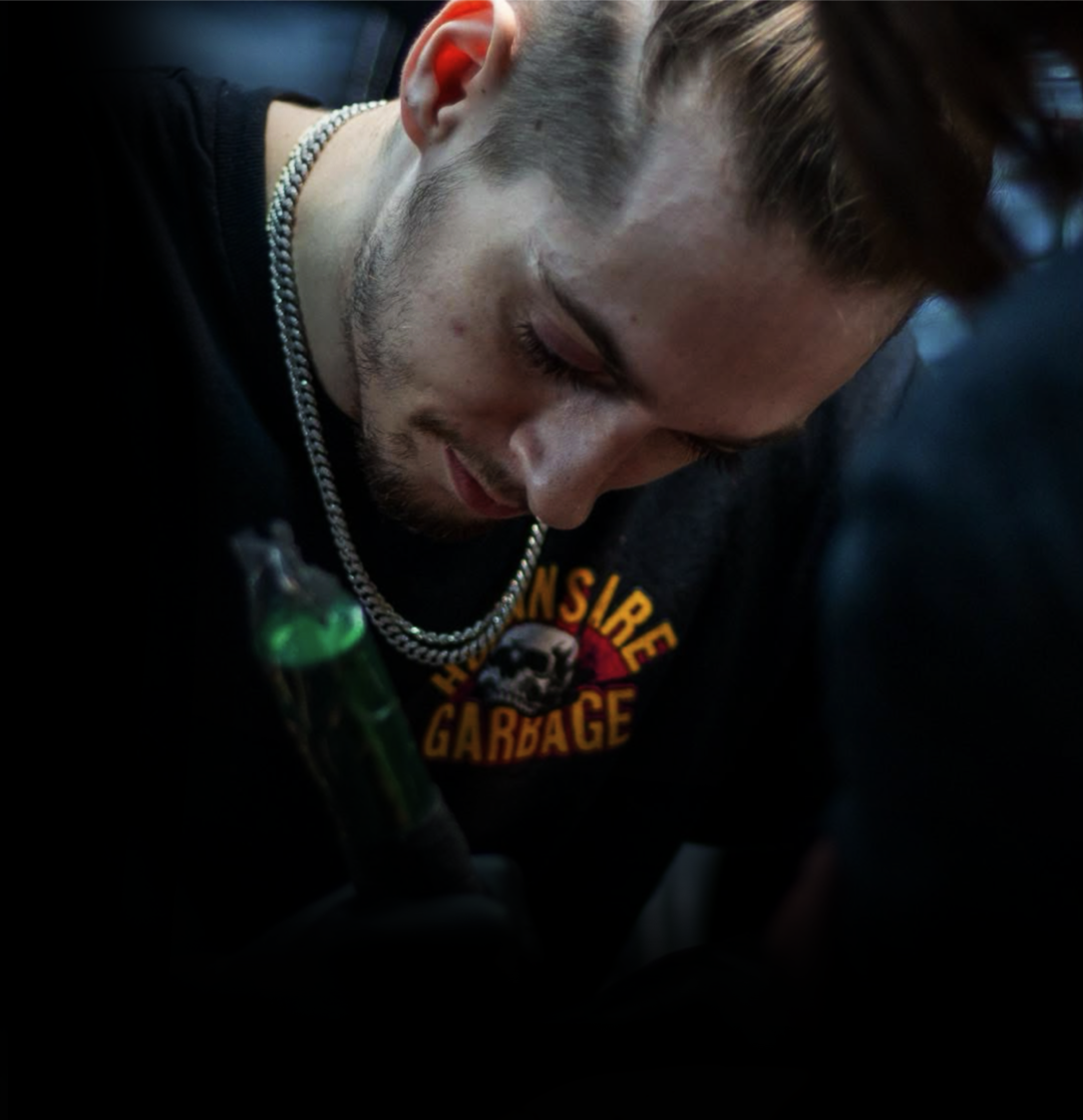 Slush tattoo artist working on a collage tattoo