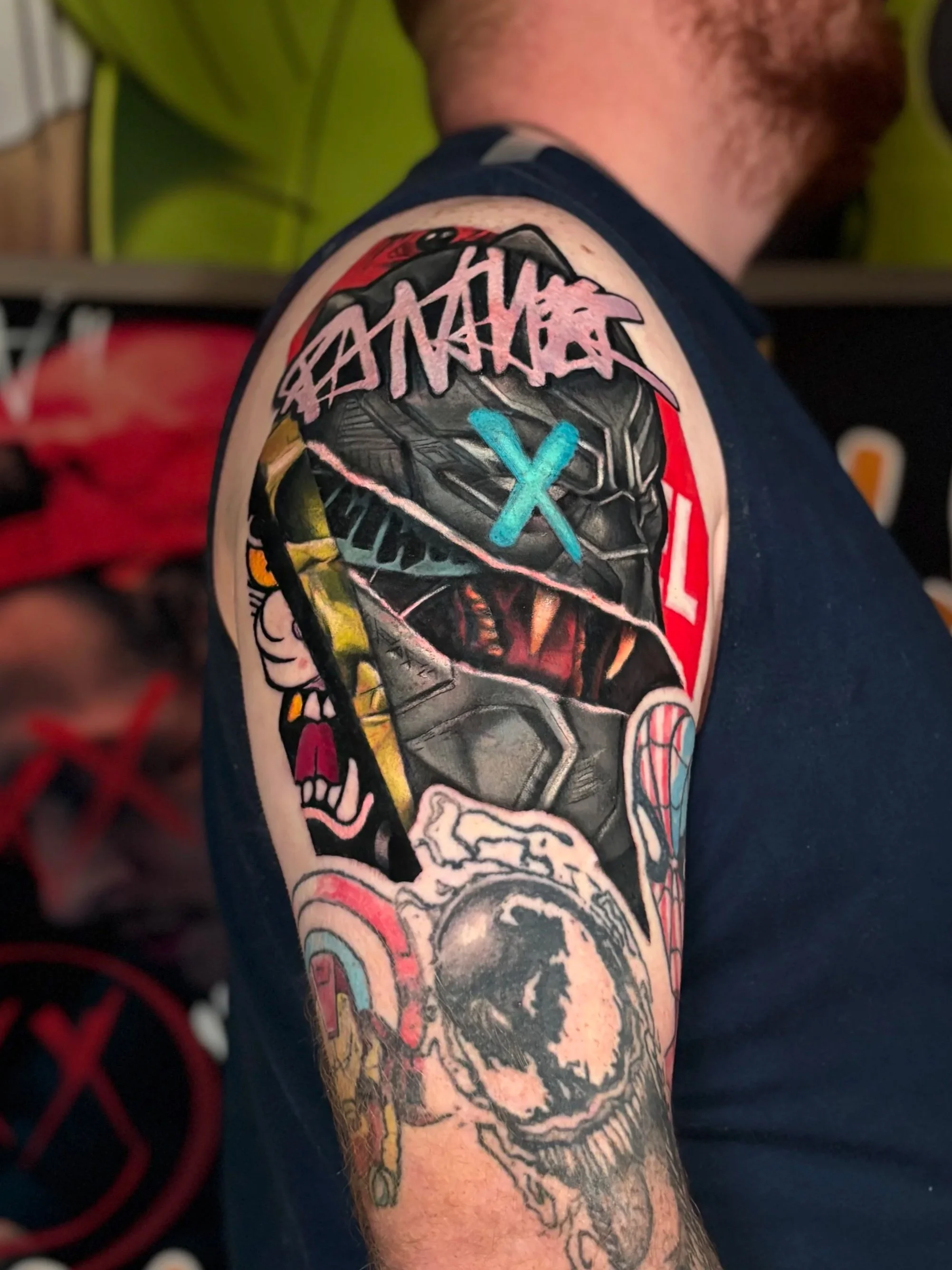 Graphic collage upper-arm tattoo with graffiti and surreal elements by Slush Tattoos