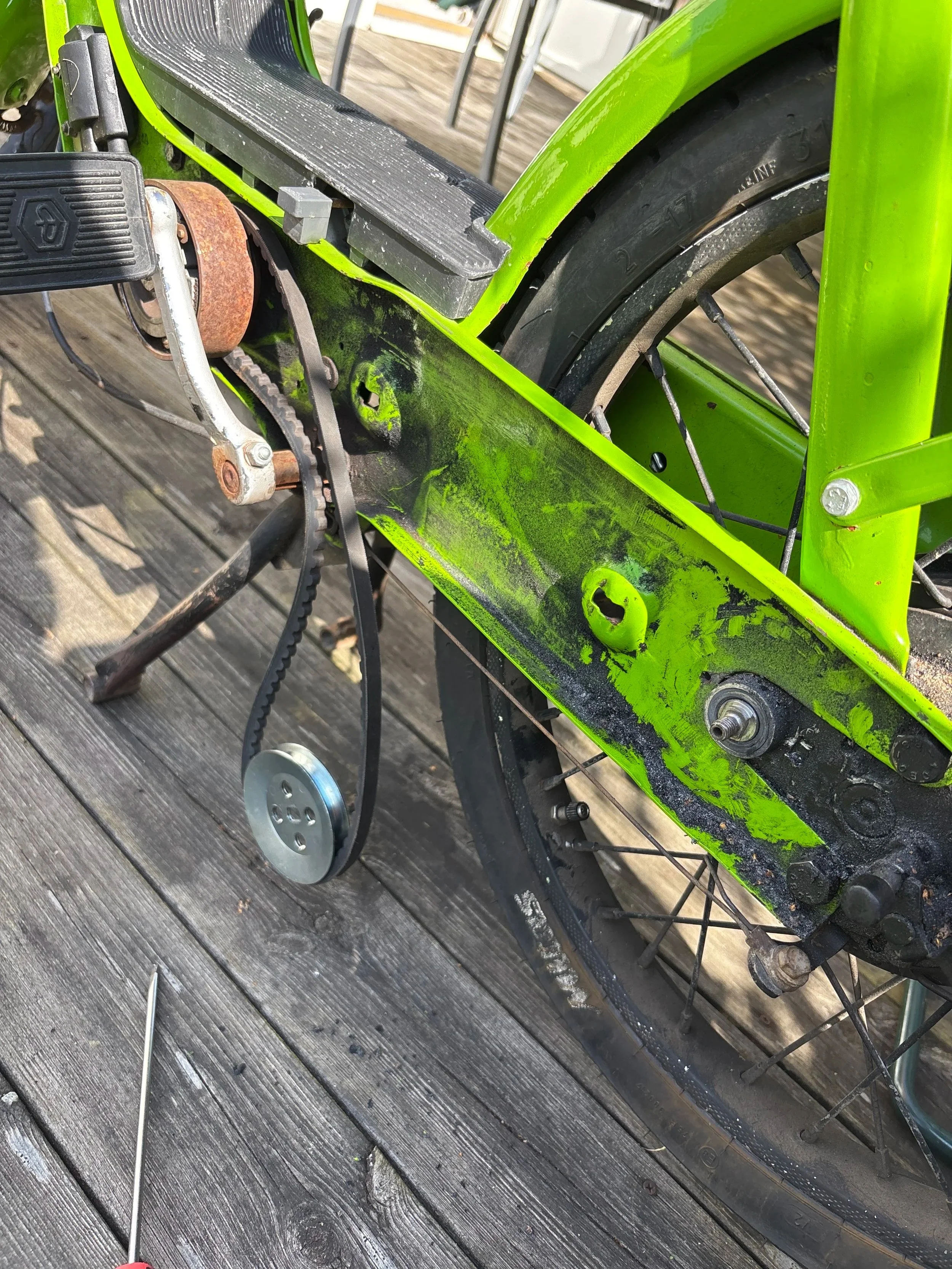 Fig 2. Picture of end of the drivetrain where the clutch connects to the final drive; can see the axel wheel hanging on the belt driver, which is connected to the rusted drive clutch