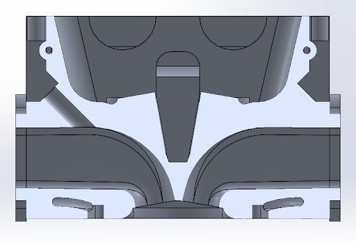 Fig 7. Cross sectional view of the cylinder head showing intake and exhaust ports, pent roof design, coolant exit channels, and mounting hole for port injector