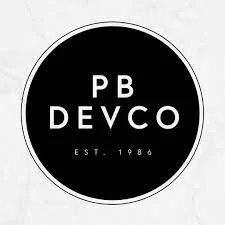 Black circular logo with white text reading 'PB DEVCO' and 'EST. 1986' beneath.