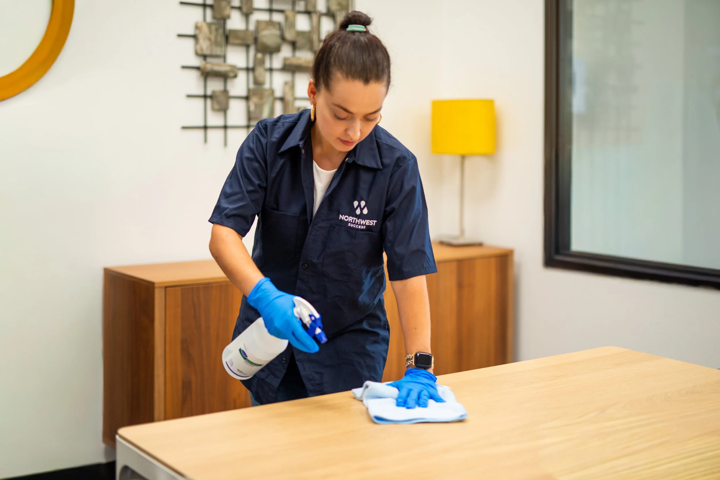 Northwest Success janitor cleaning conference room table