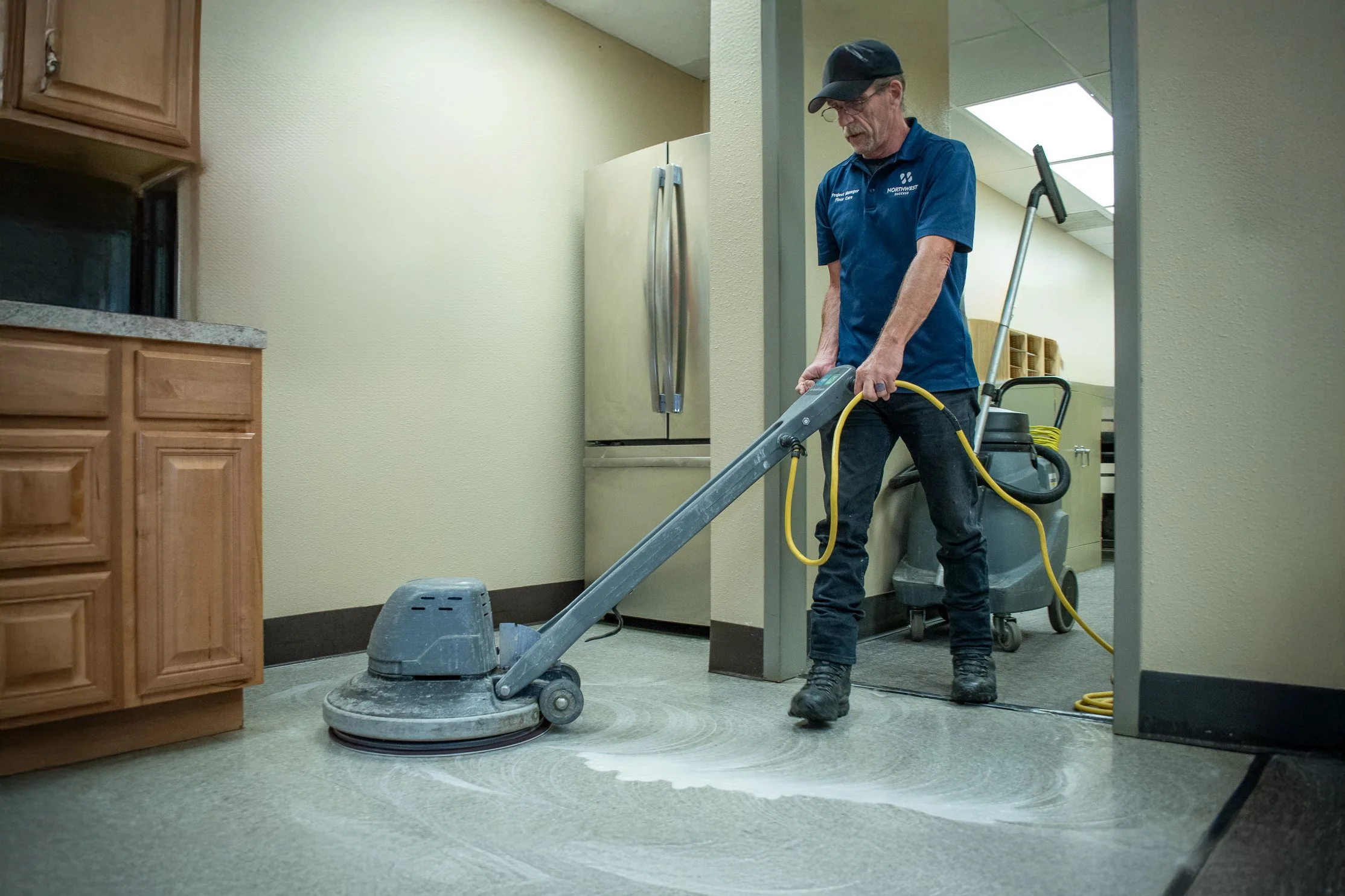 Northwest Success janitor operating hard floor cleaner