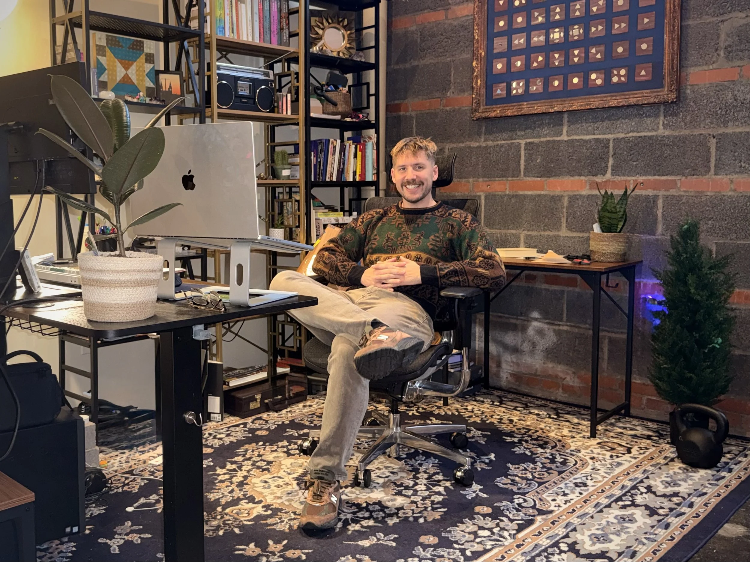 A professional portrait of Luc Gensler in his home-office setup.
