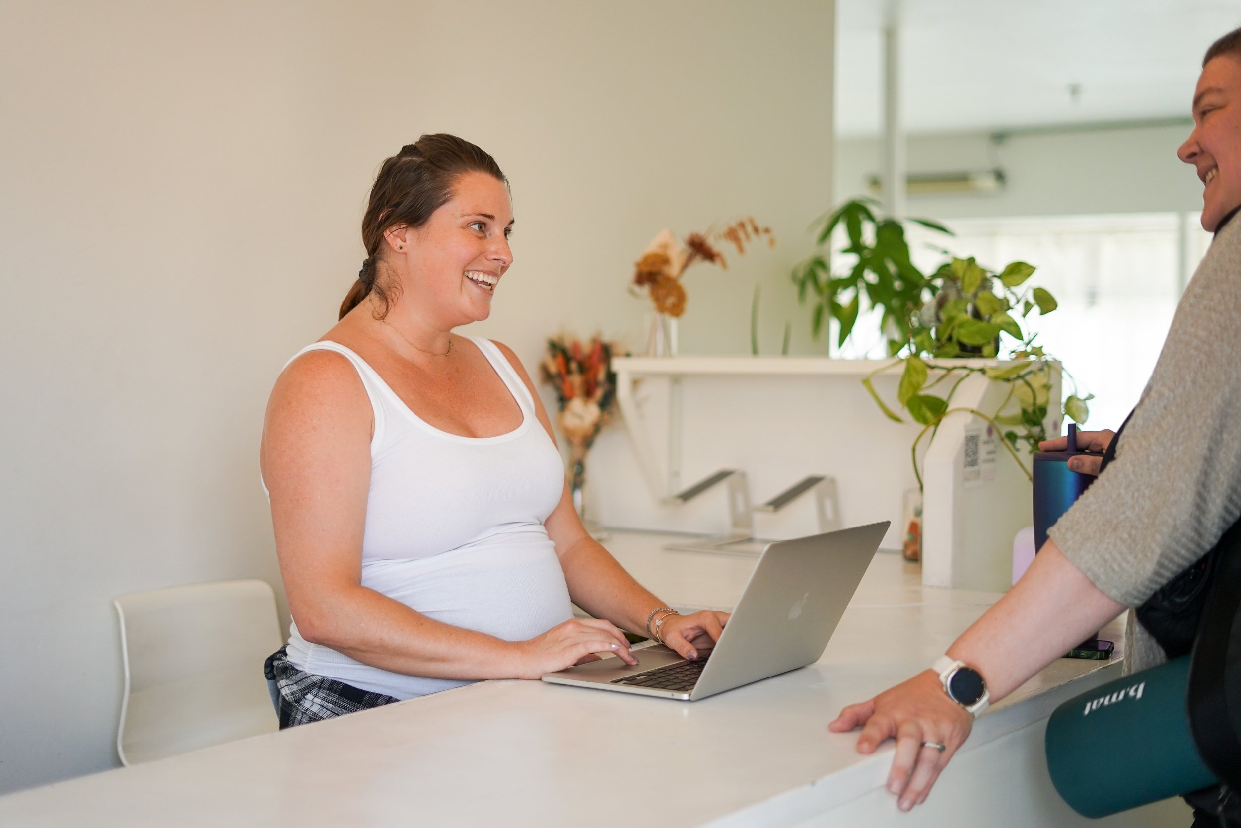 smiles at front desk honey yoga san diego