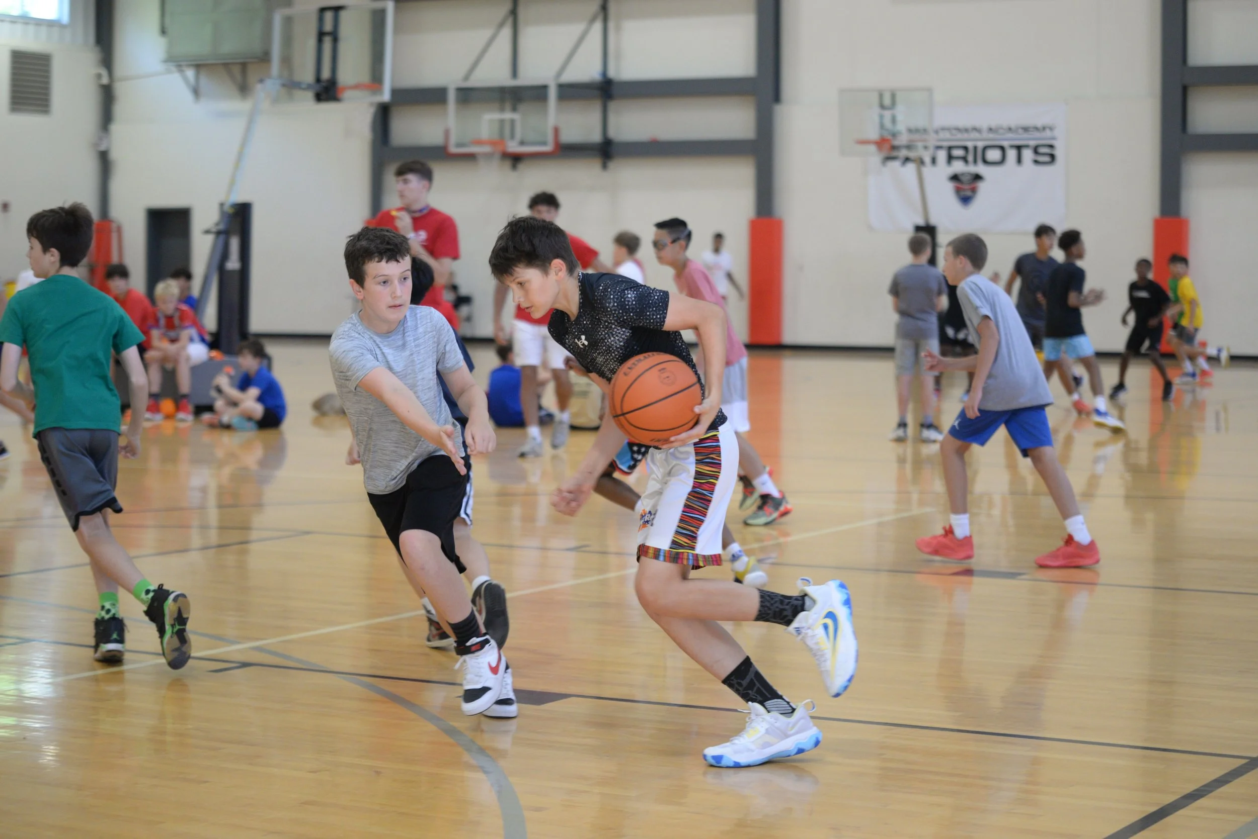 Two campers playing basketball in the Germantown Academy Summer Camp Sports Camp in Fort Washington, PA