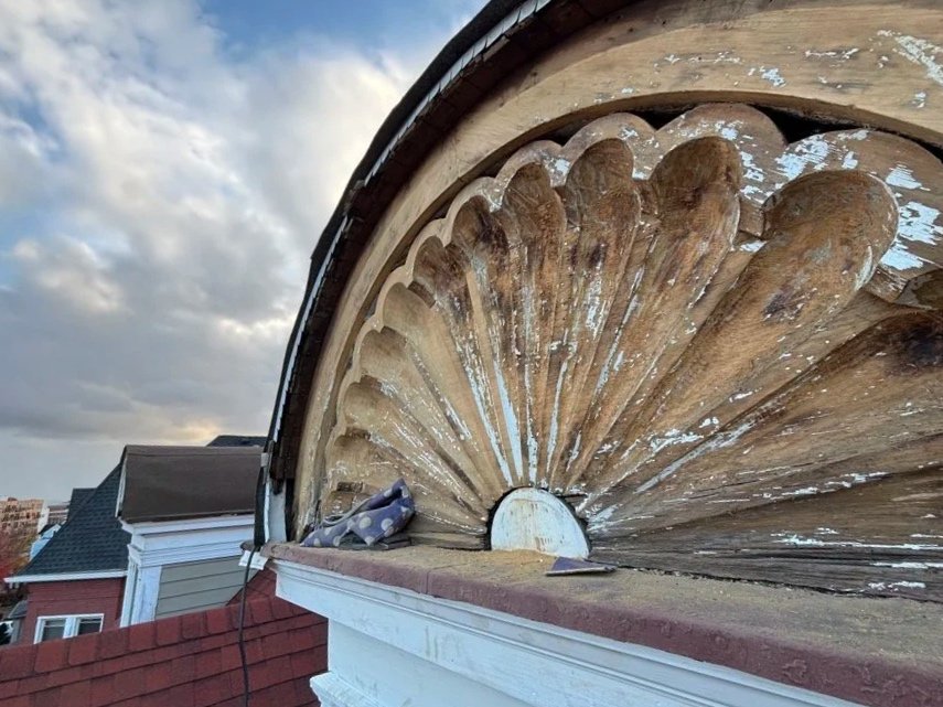 Restoration of the pediments began by removing the moulding, stripping the paint with an infrared heat lamp, sanding, carving off loose and fragile sections.