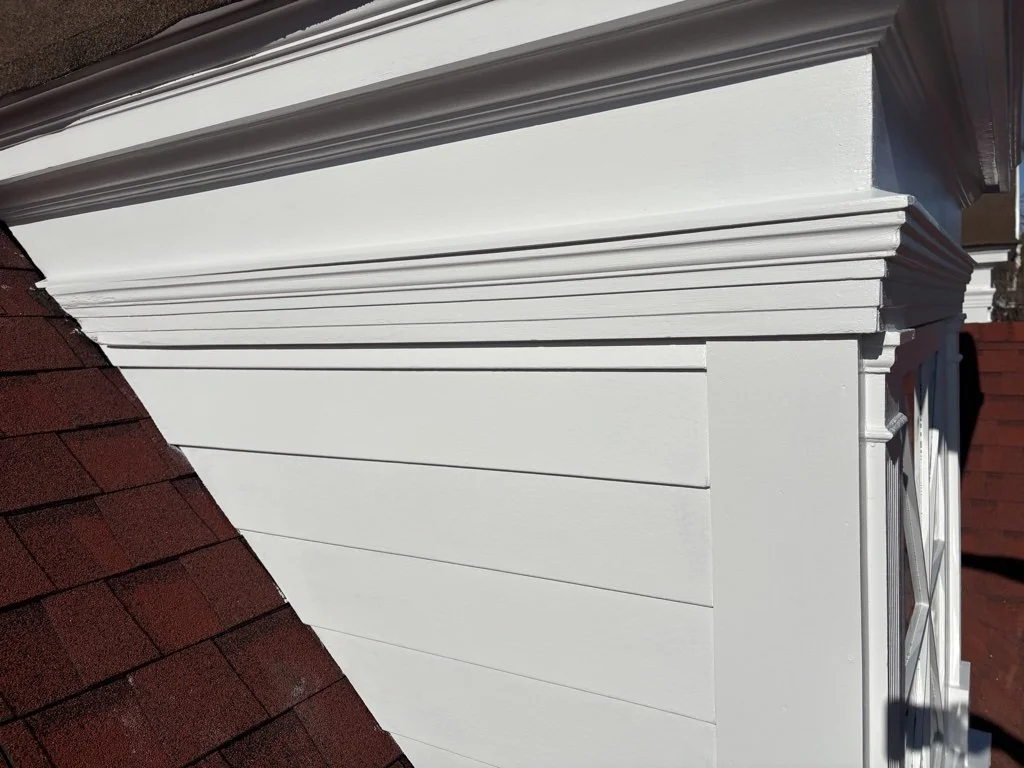 Every part of all four cheeks were completely dismantled.  Shingles were replaced with cement board siding.  As much of the lumber and trim that reasonably could be, was salvaged and reused. But this middle band of fascia moulding was far too deterio