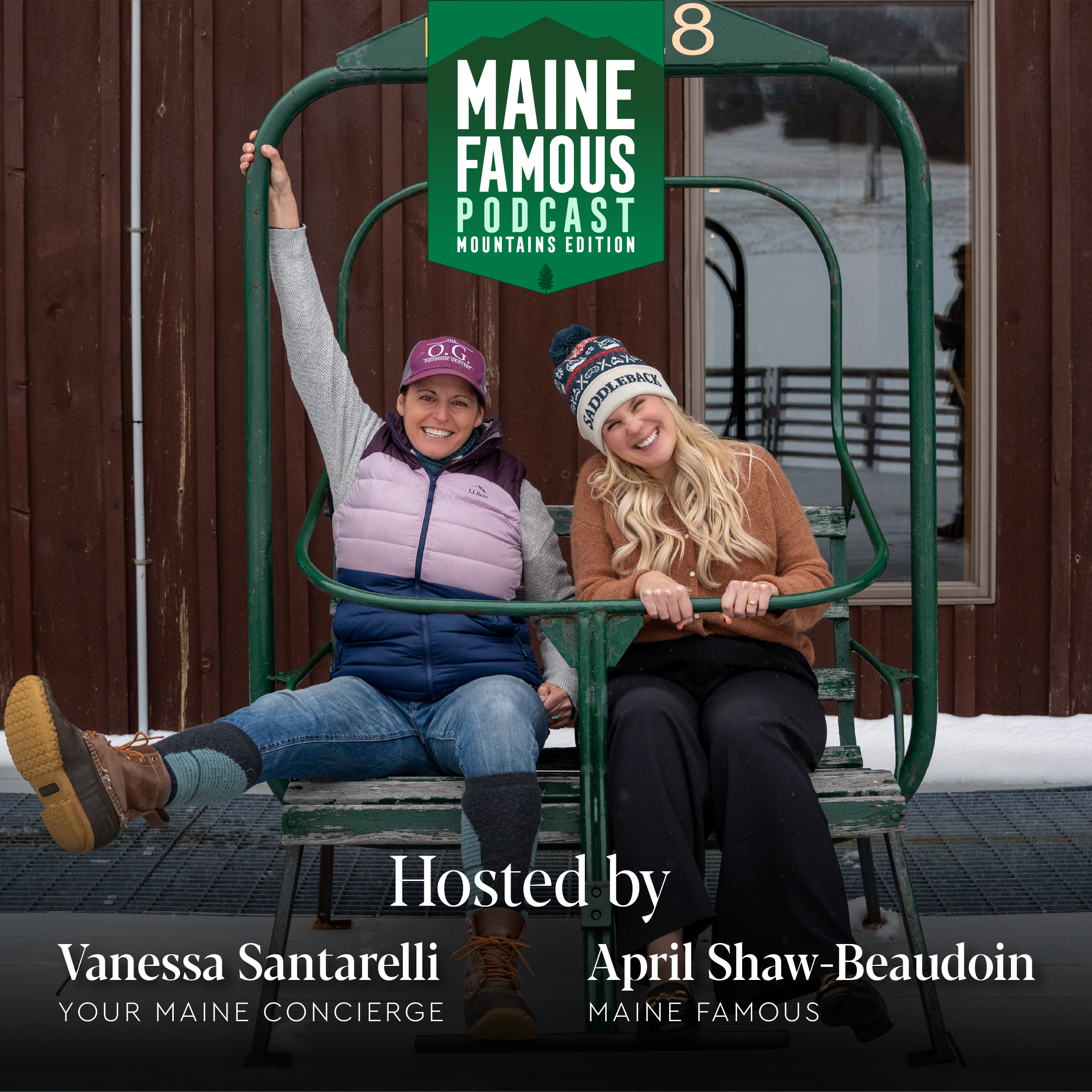Two women sitting on a ski lift chair, smiling. The woman on the left is wearing a purple baseball cap, a layered vest, and jeans. The woman on the right is wearing a beanie, a brown sweater, and black pants. They are outside a wooden building with snow on the ground.
