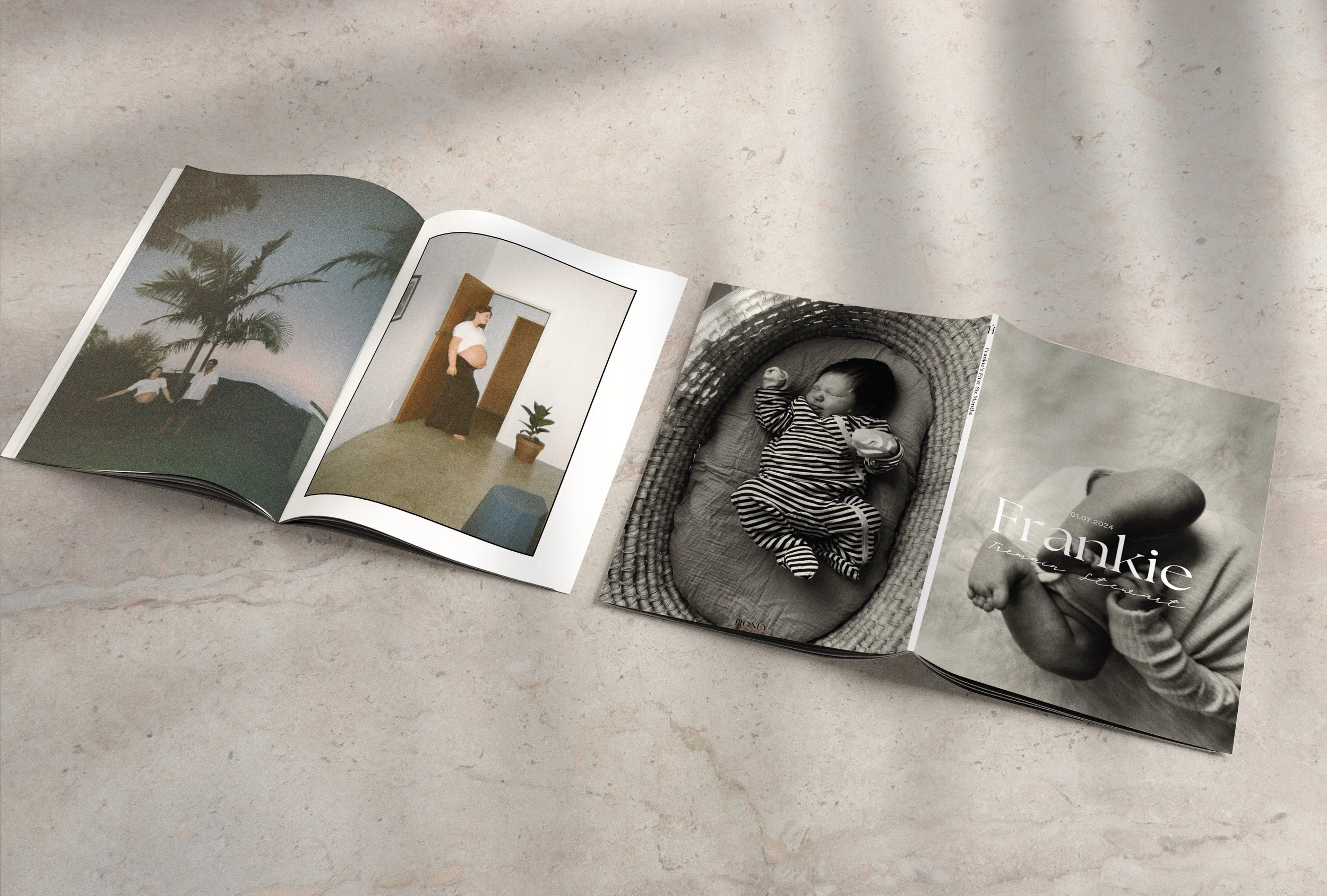 Open photo album with pictures of a pregnant woman, a sleeping baby named Frankie, and a black-and-white photo of a baby holding a foot