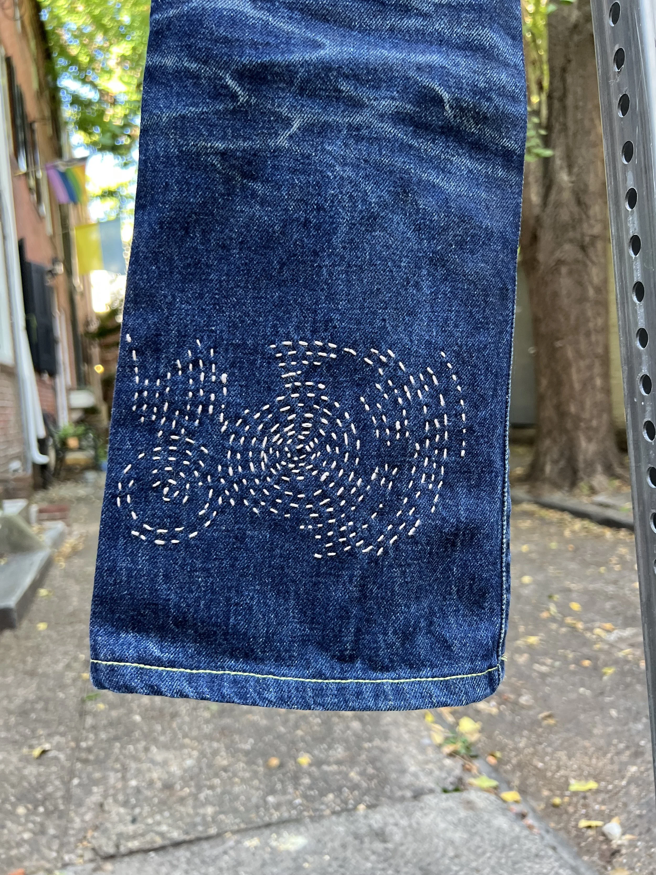 Circular sashiko-inspired mending on denim