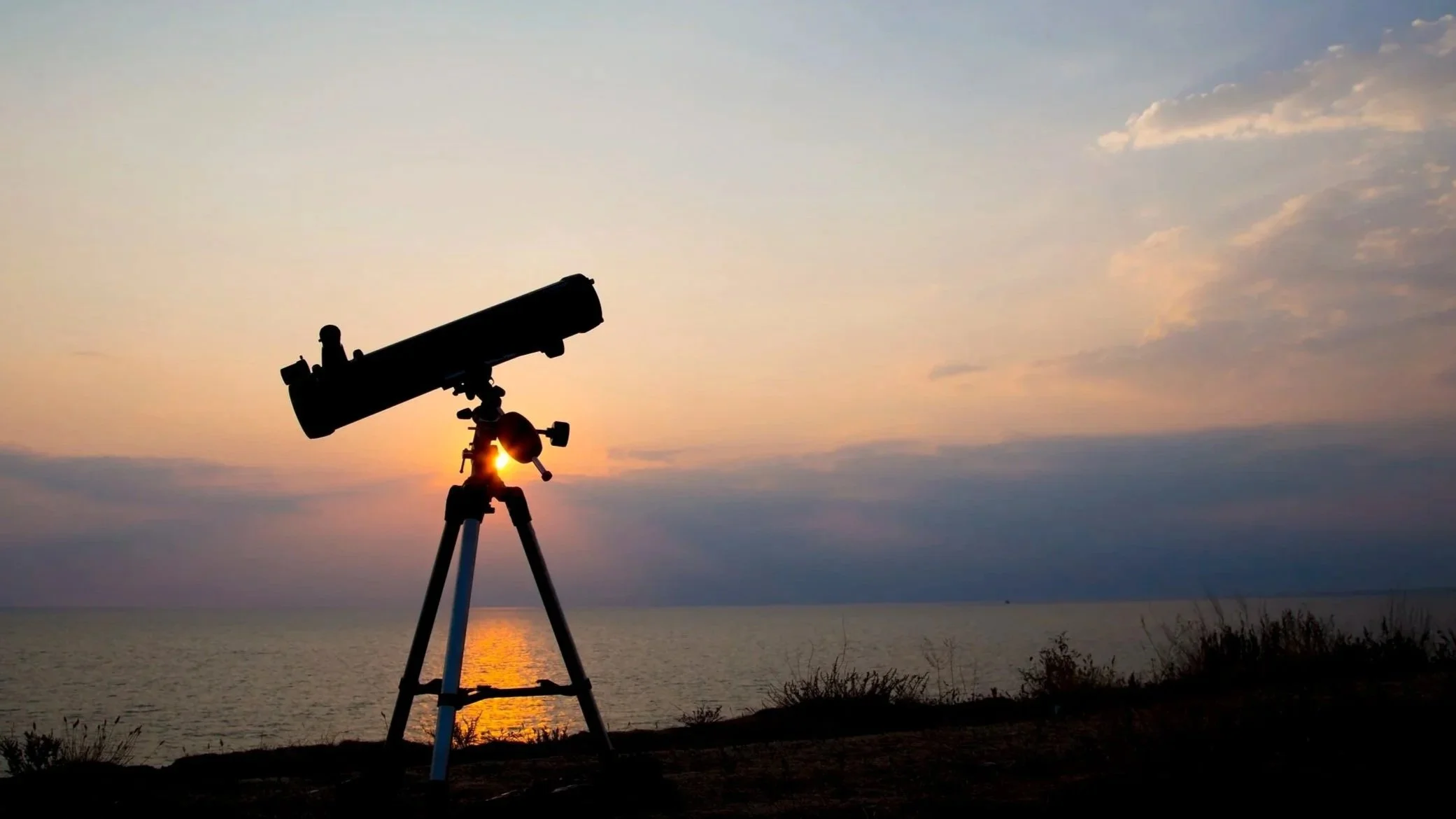 Telescope pointed toward the horizon at sunset, symbolizing detailed actuarial analysis and deeper insight.