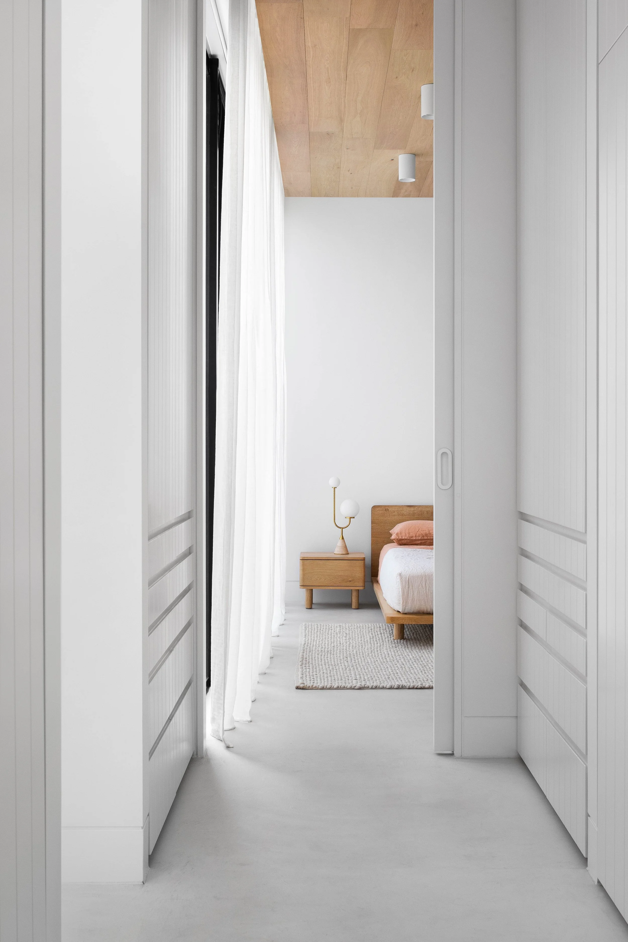 Seamless, artisan microcement floors in a modern wabi sabi bedroom