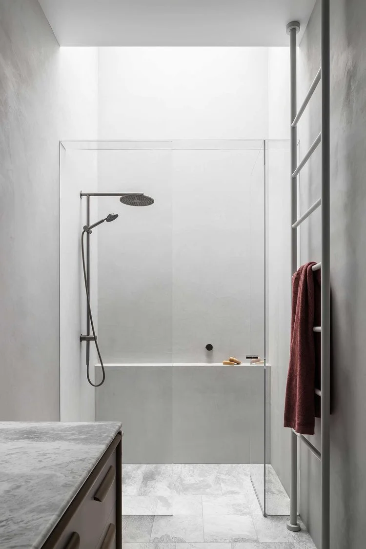 Minimalist bathroom with microcement walk-in shower