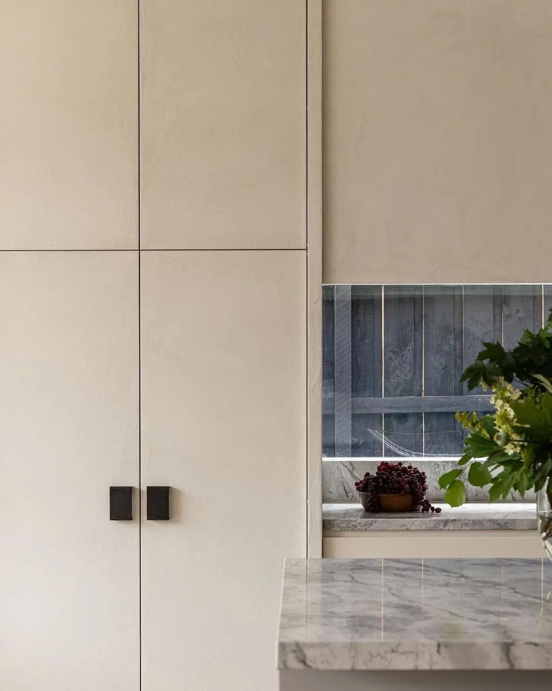 Modern kitchen with custom beige microcement built in kitchen cabinets perfect for elevating your next kitchen remodel.