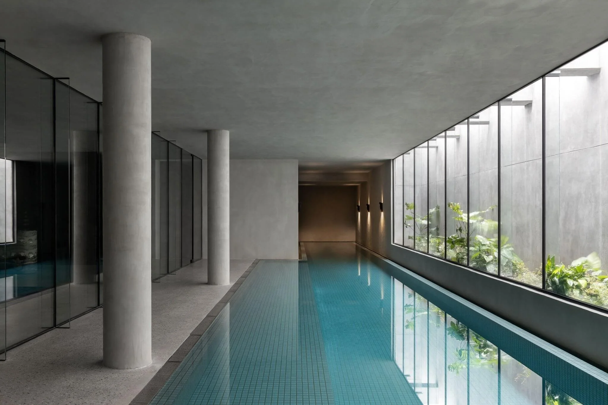 Indoor swimming pool with seamless microcement application for floor to ceiling in a coastal luxury home