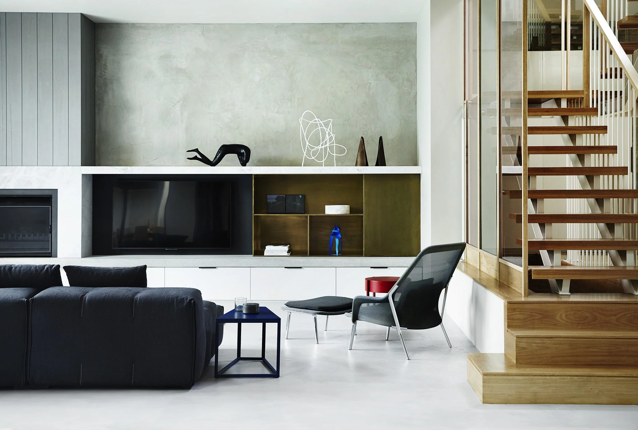 Artisan, warm microcement accent wall in a modern living room.