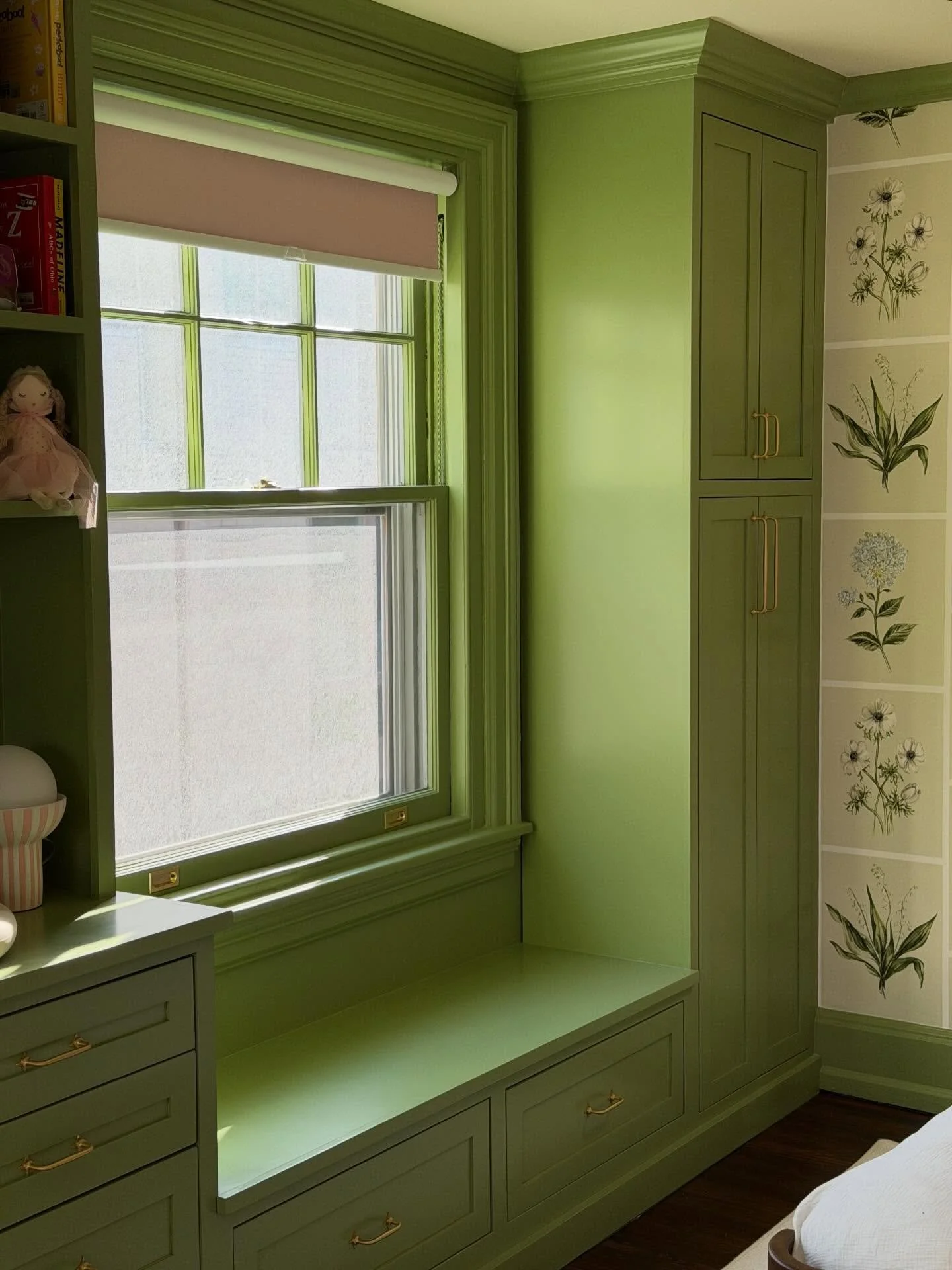 Not your average nursery.

This unit features an integrated dresser, shelving, radiator cover, bench seat, framed by matching armoires on either side of the room. Building and installing this piece was a real treat. 

As a father, projects like this 