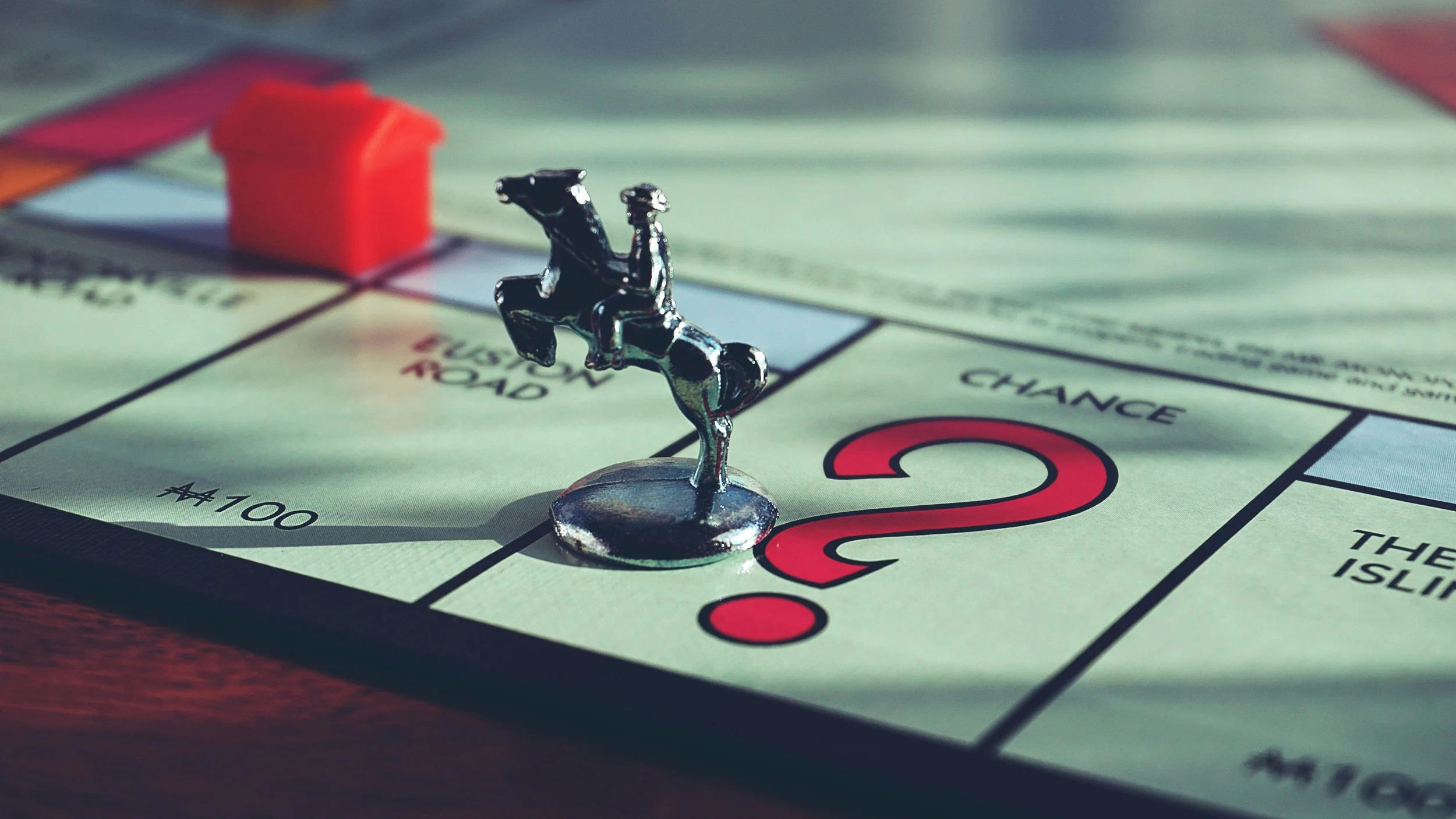 A close up shot of a monopoly game board, with one of the pieces placed on "chance". Representing the insights of Joseph Catalino on helping kids learn to lose with grace.
