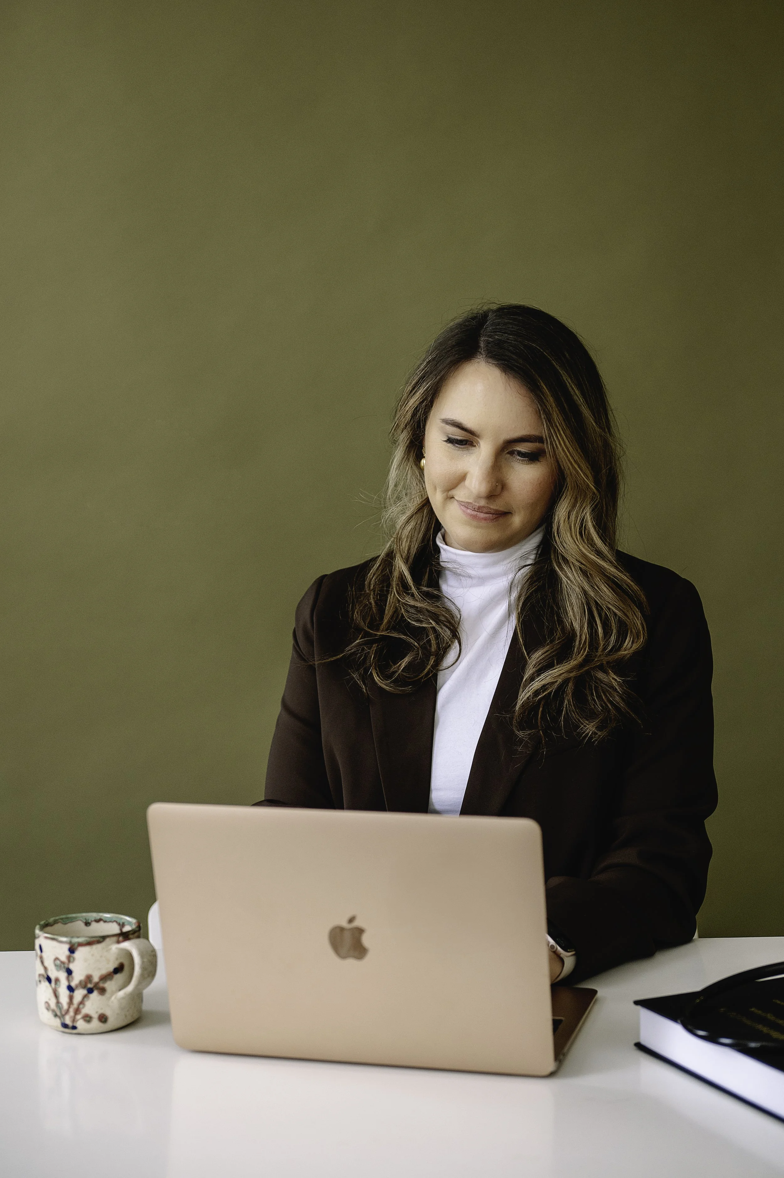 Dr; Warren  working on laptop smiling softly