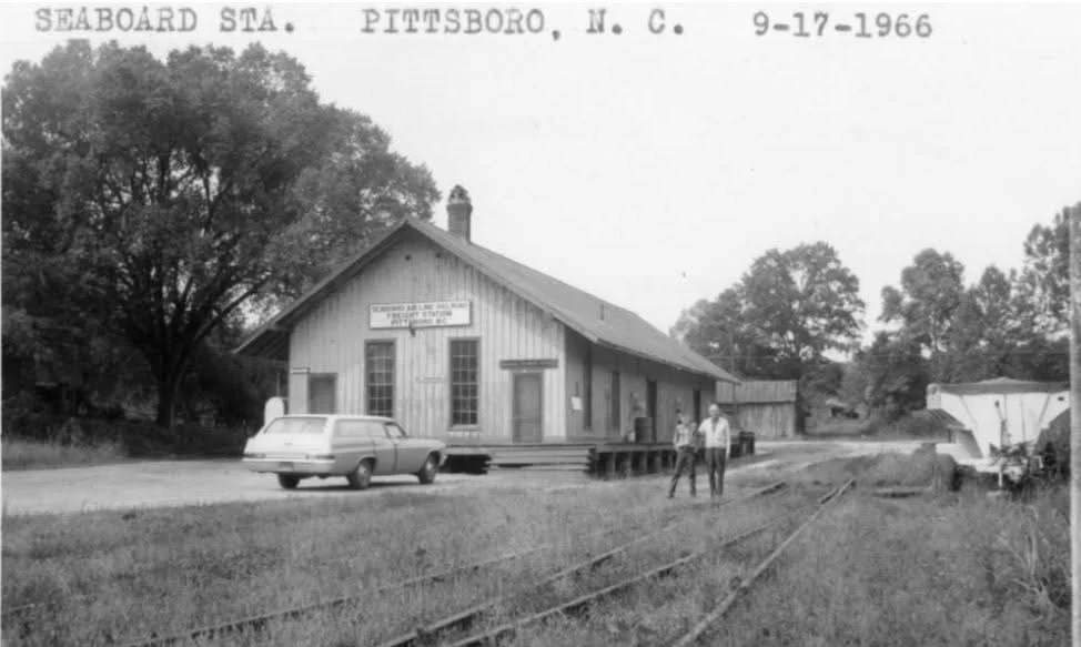 Black and white photo of the Seaboard Station in Pittsboro, North Carolina, dated September 17, 1966. It stood beside what is now the Captain J. F. Alston house, the current location of Gandy Coffee and Purrsuasion Cat Cafe