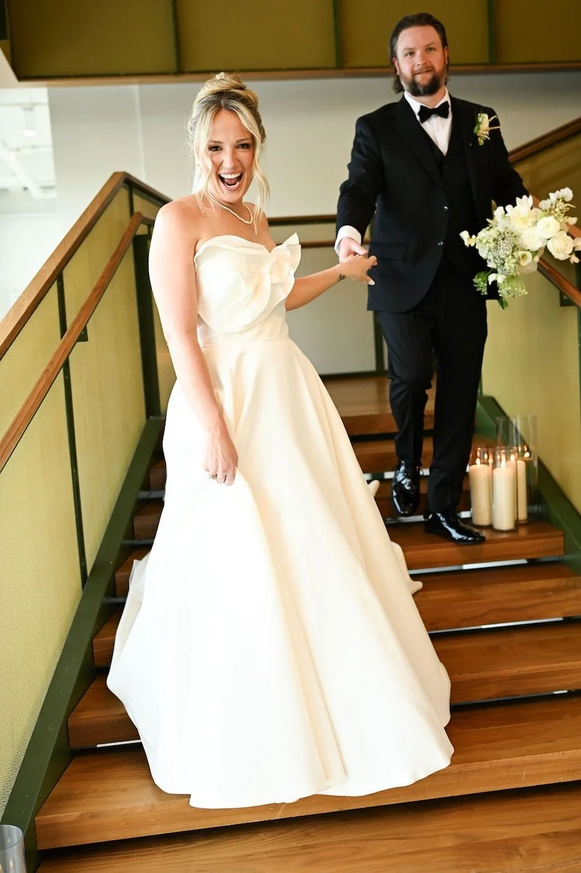 beautiful bride with blonde hair wearing her white bridal gown and an updo with clip in extension