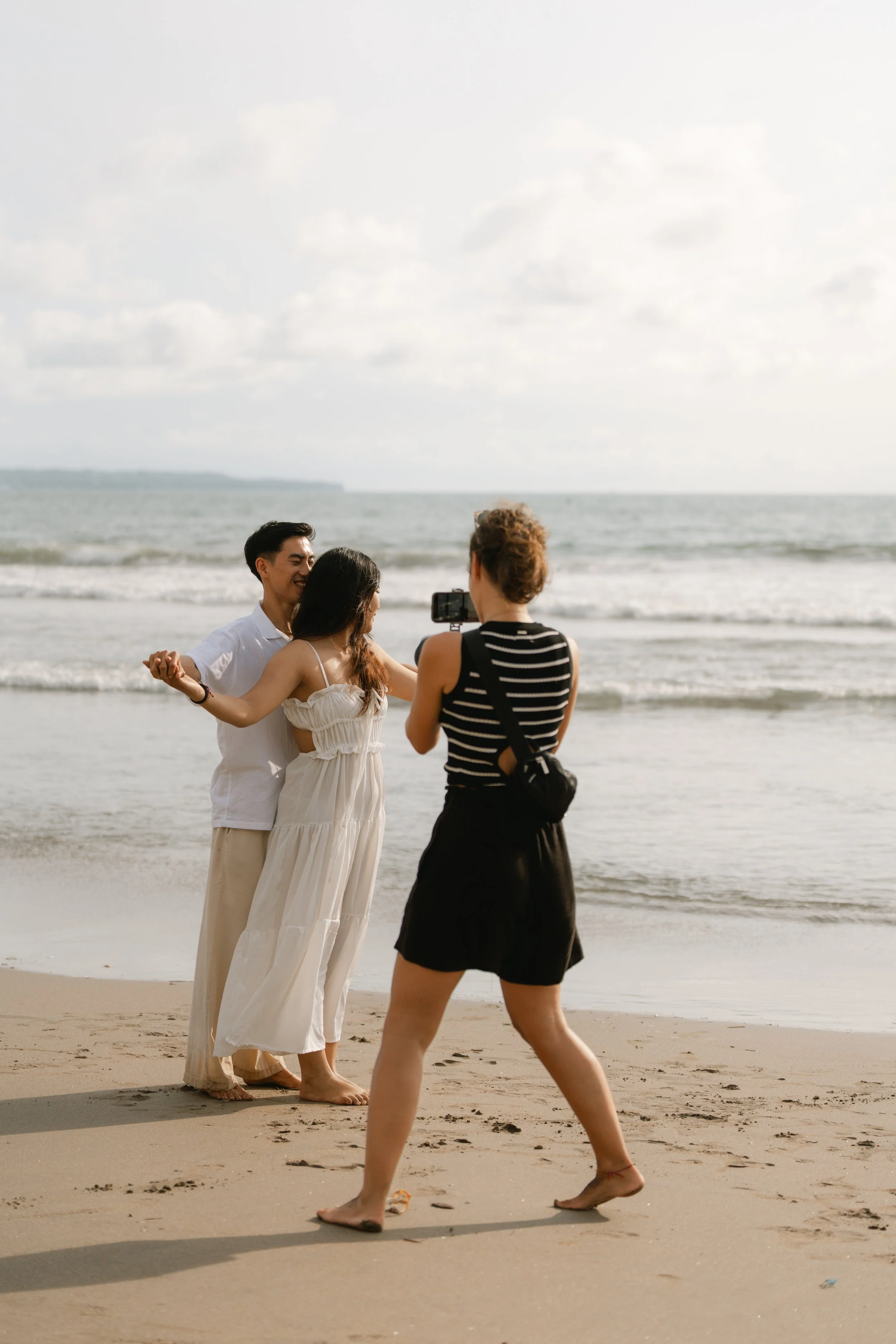 Behind the scenes: Destination Wedding Photographer Jara Lenz in Bali beim Fotografieren eines Brautpaares im natürlichen Licht am Strand.