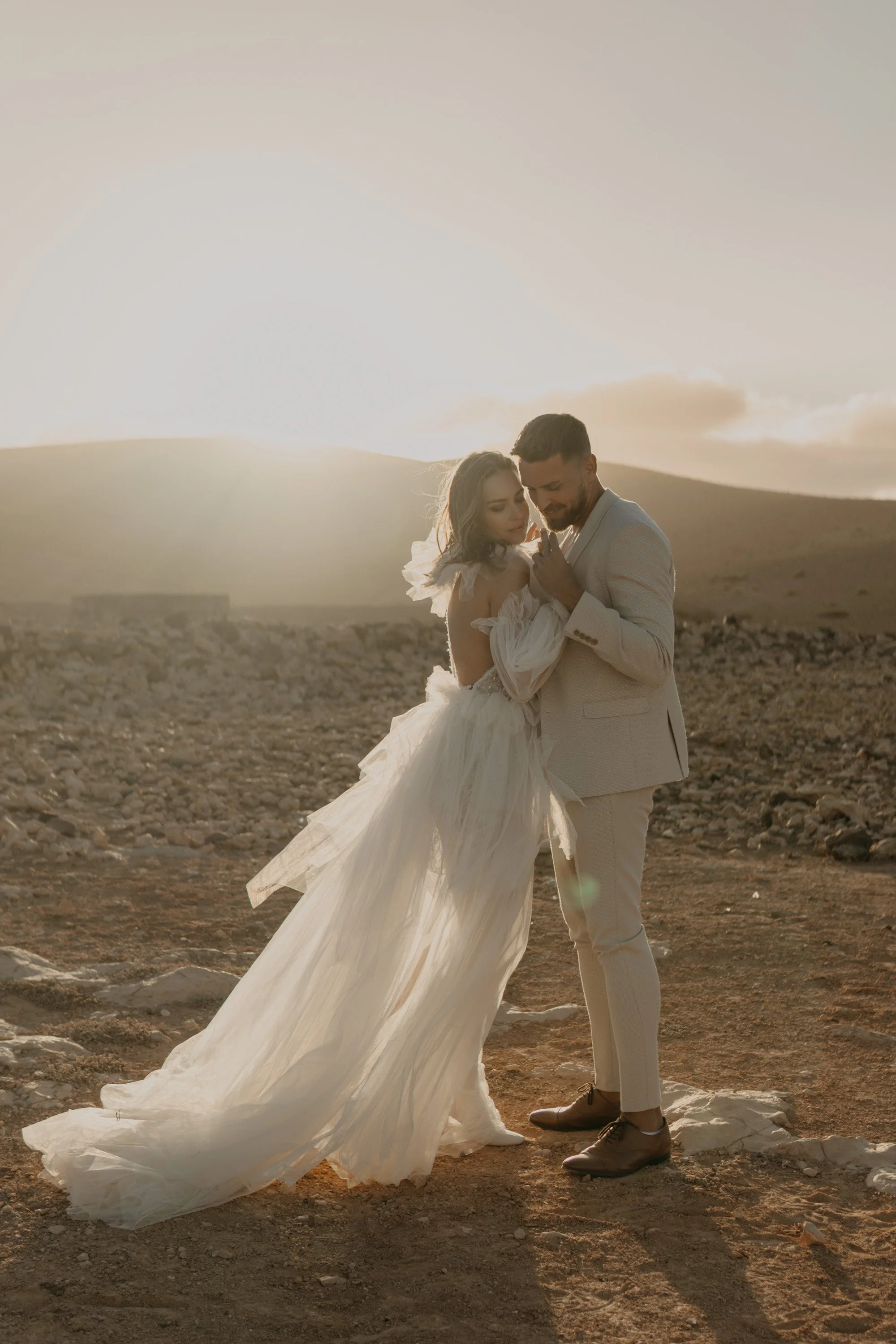 Destination Wedding Couple holding hands during sunset shoot in the dunes of Fuerteventura Europe.