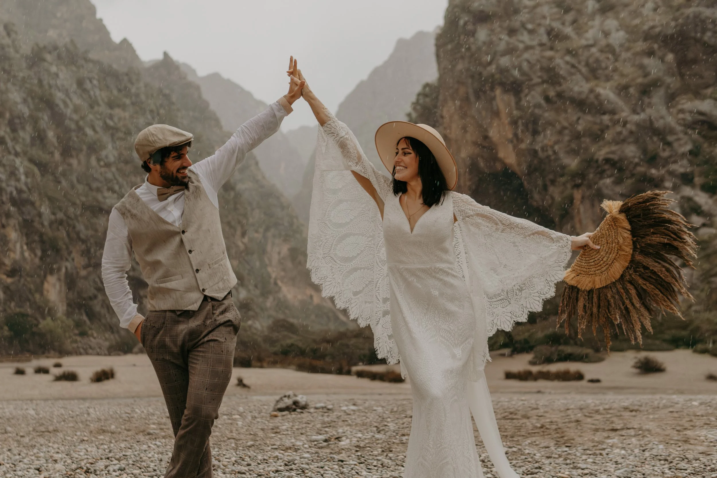 Wedding Couple dancing in the rain at the beach from Mallorca, Spain. they eloped in beautiful Spain nature.  moments captured by Jara Lenz.
