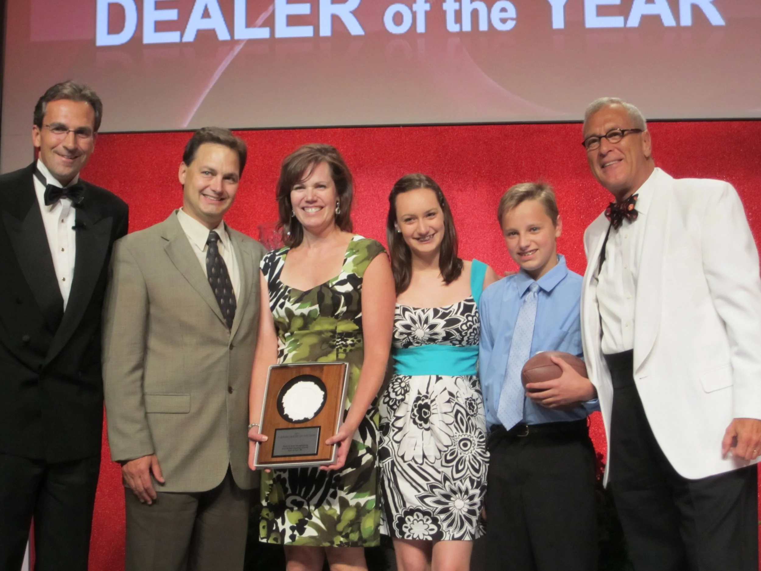 Kris, Doni, Kristin, and Mitchell Houghtaling accepting an award from BERNINA in 2012