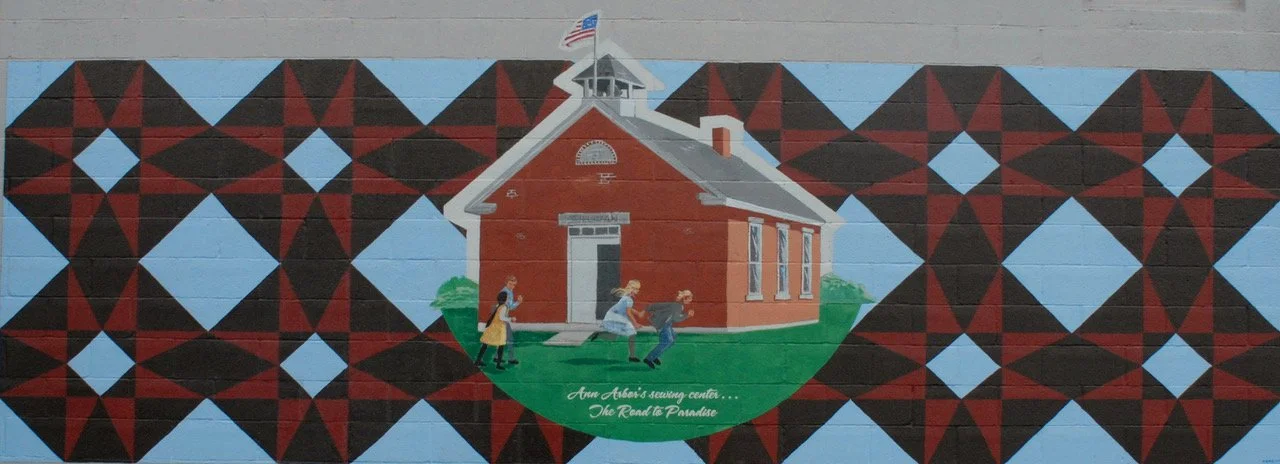 Mural on the back of our building, commemorating the building's educational roots. Painted by local artist, Zeke, in 2007.