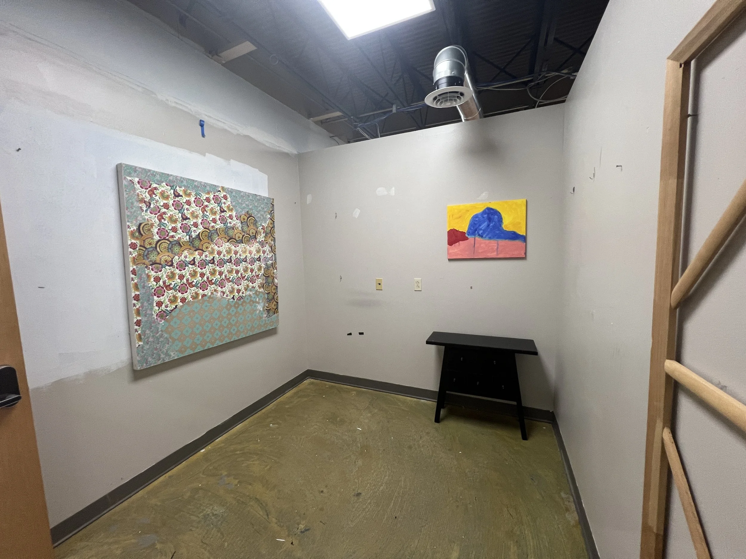 studio space with paintings on the wall
