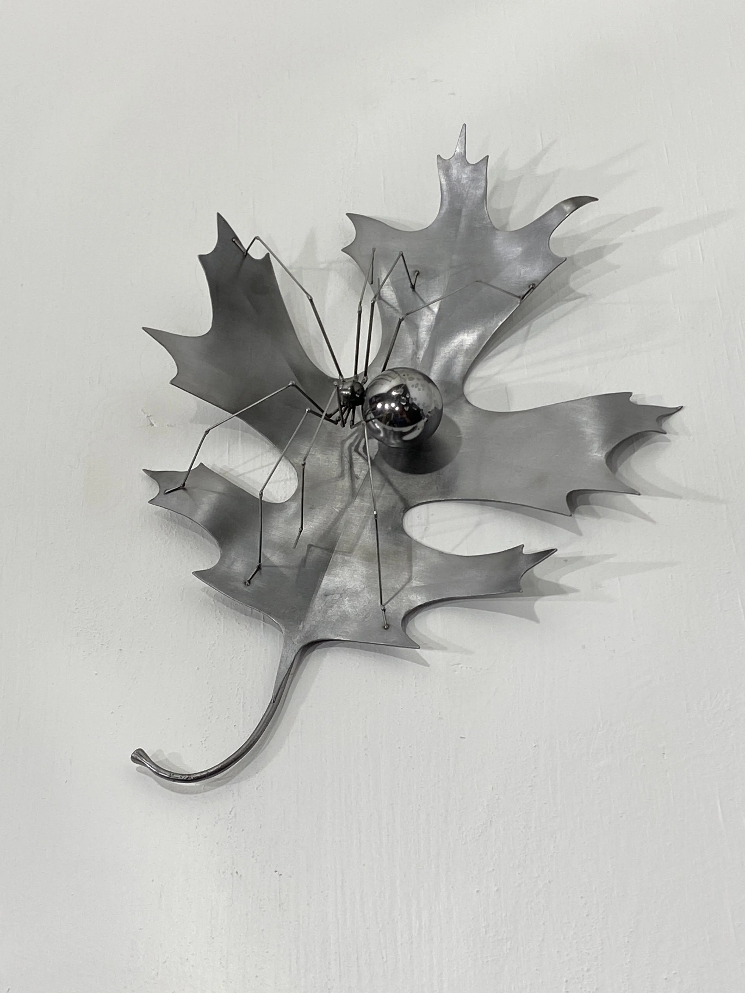 "Oak & Orb", 2025, Steel+CC, 2"Hx7"Wx5"D. Wall hanging sculpture.  Available - email for info.