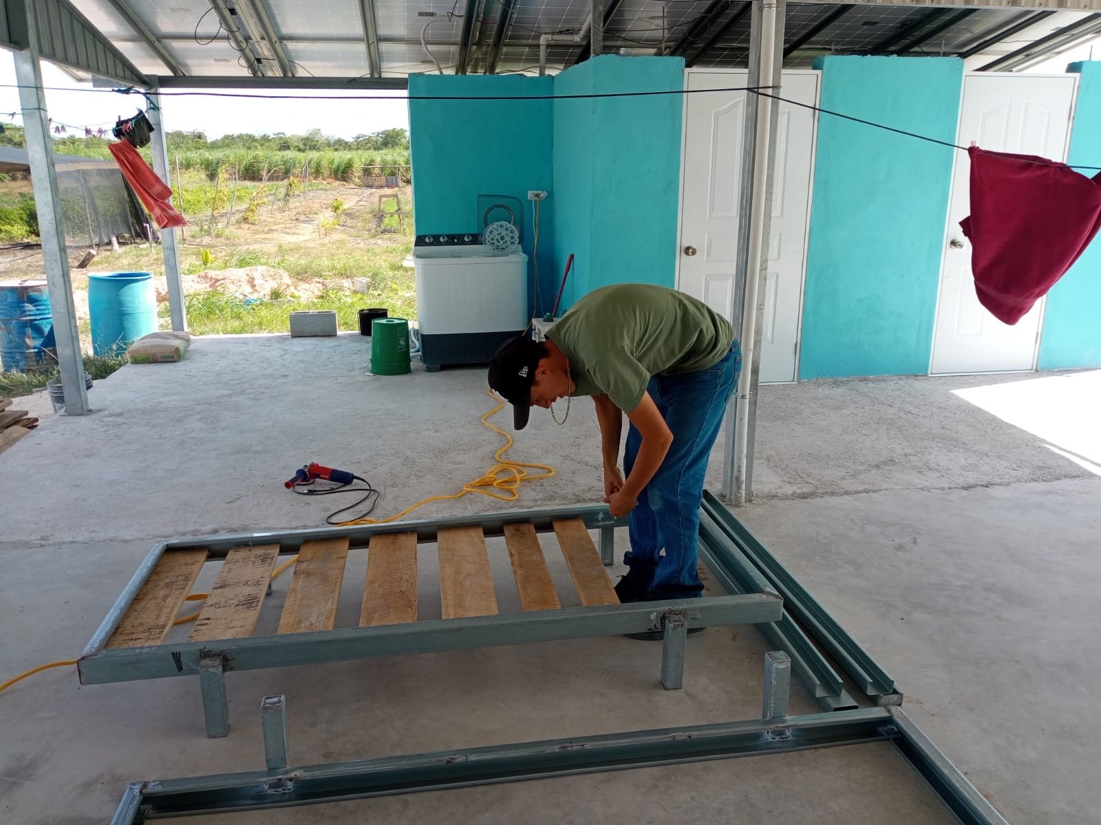 Local craftsman building a handmade bunkbed in Louisville Village, Corozal District, Belize through True Belize's workforce development program.
