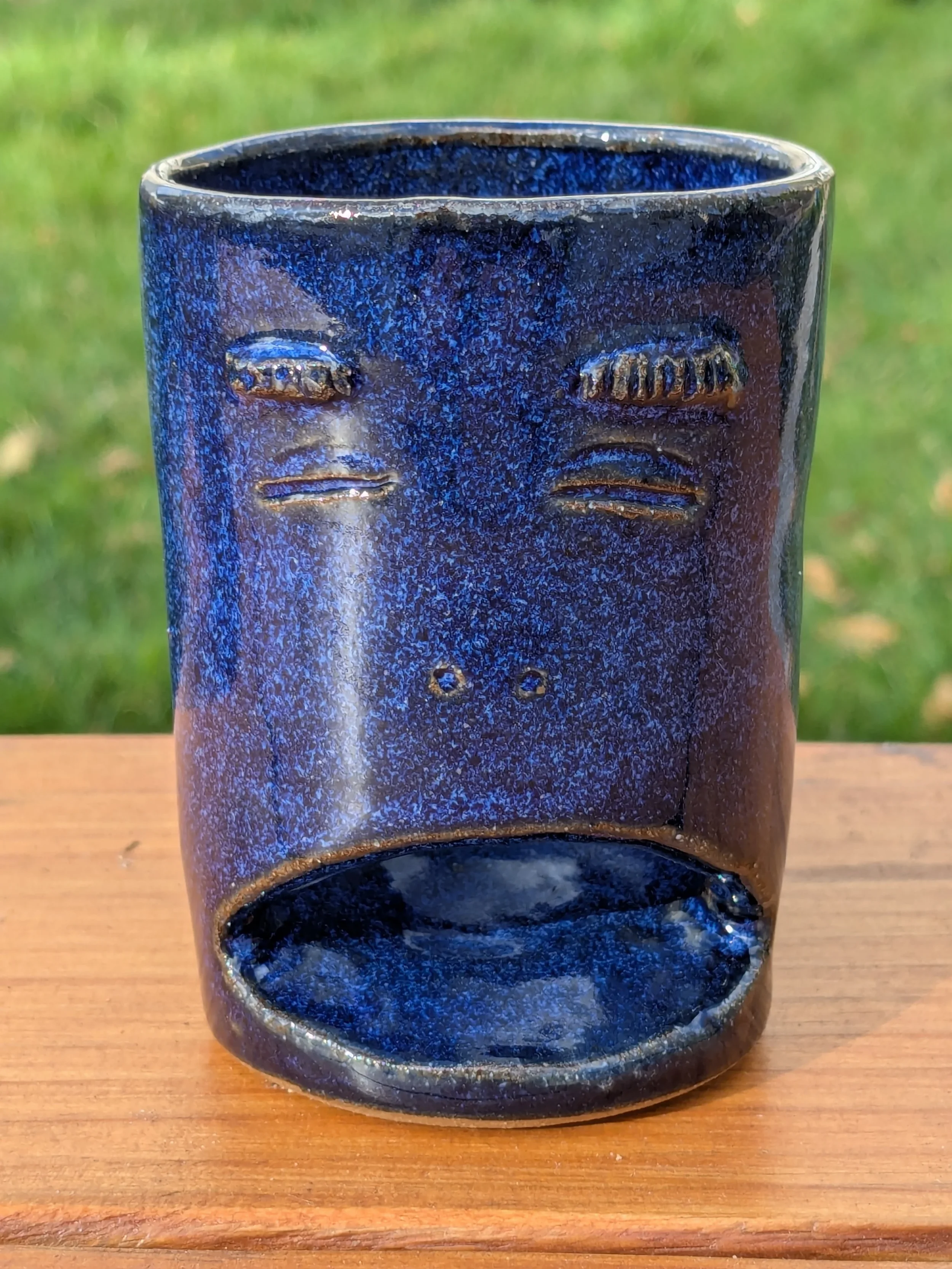 yawning blue toothbrush holder.webp