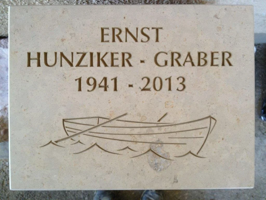 Gedenktafel für Ernst Hunzikar-Graber mit den Jahren 1941 bis 2013 und einer Zeichnung eines Bootes.