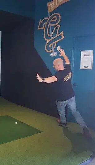 Man running in celebration of a successful shot on the golf simulator at Good Sport Napier.webp