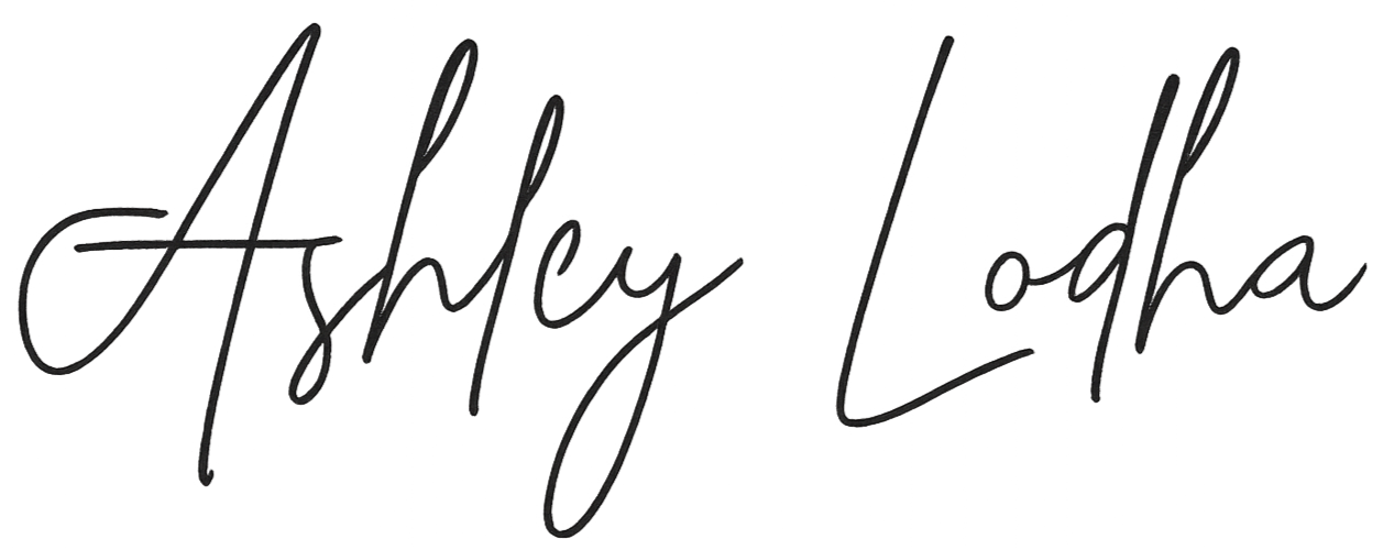 Stylized handwritten text that says "Ashley Loda"