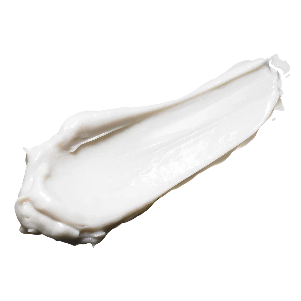 Creamy white substance spread in a curved shape, likely a cosmetic or skincare product.