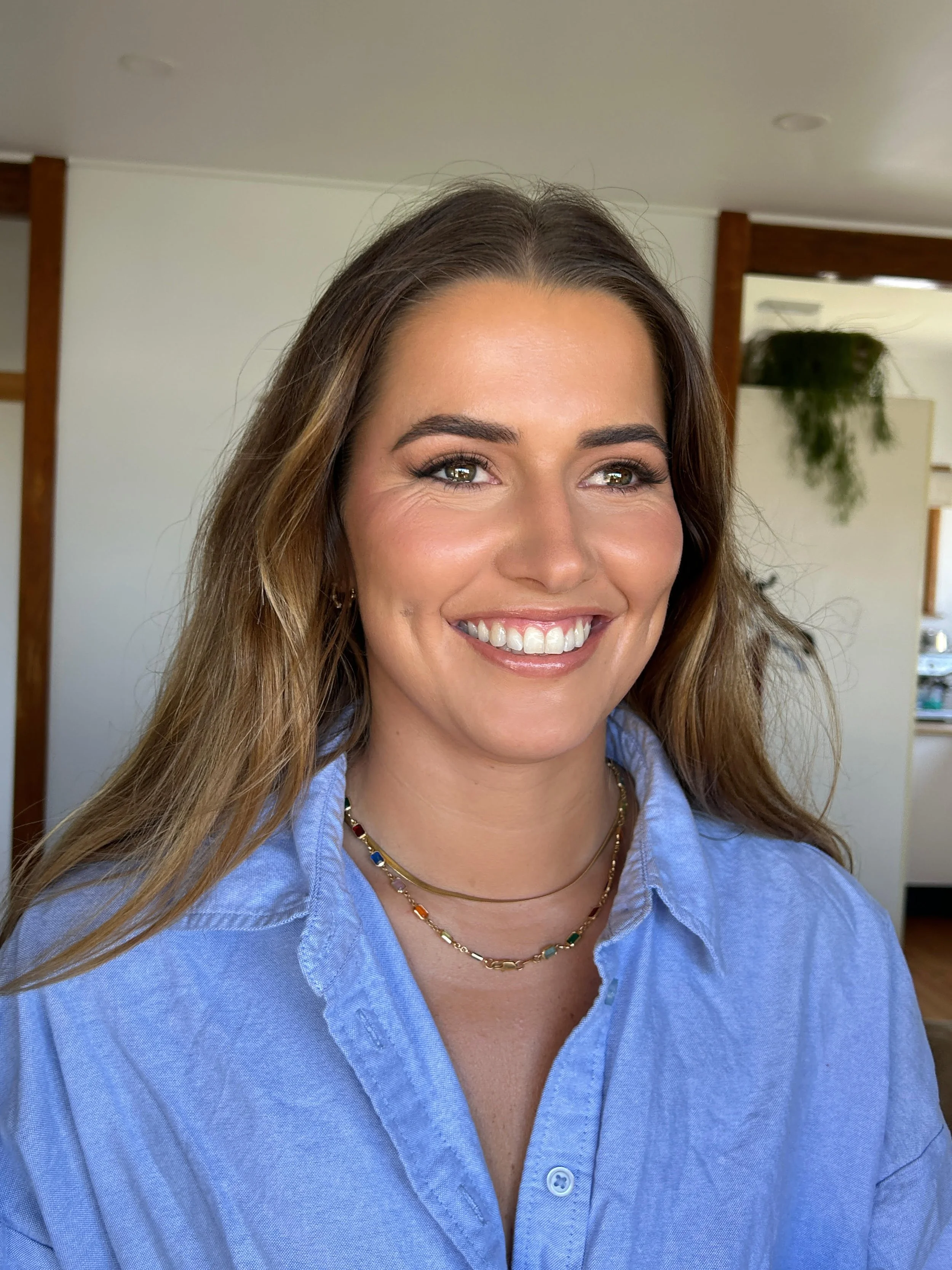 blonde hair smiling girl in blue shirt