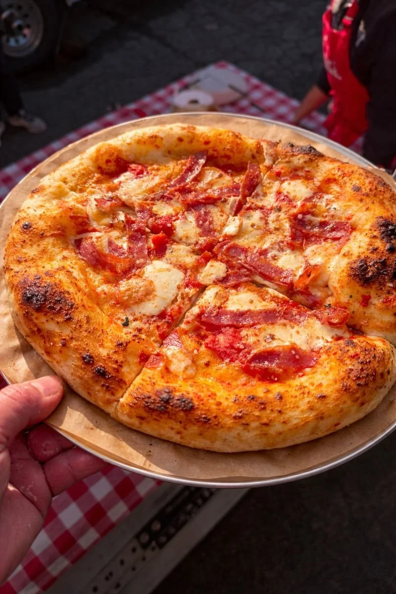 Meat Lovers pizza served from Soci Pizza truck catering in Raleigh-Durham, NC, featuring pepperoni, sausage, pancetta, and fresh mozzarella.